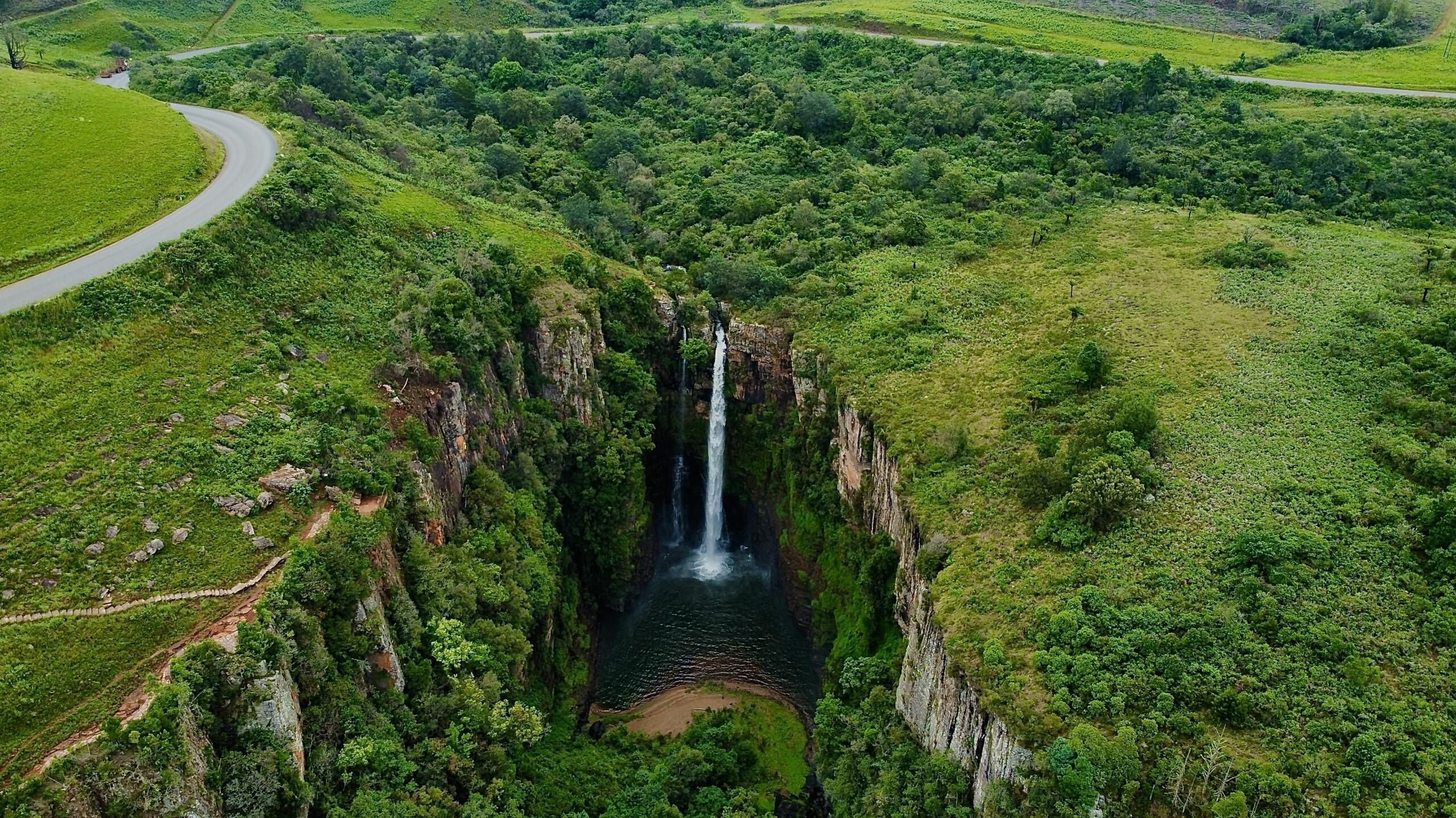 An image of a waterfall in a lush valley.