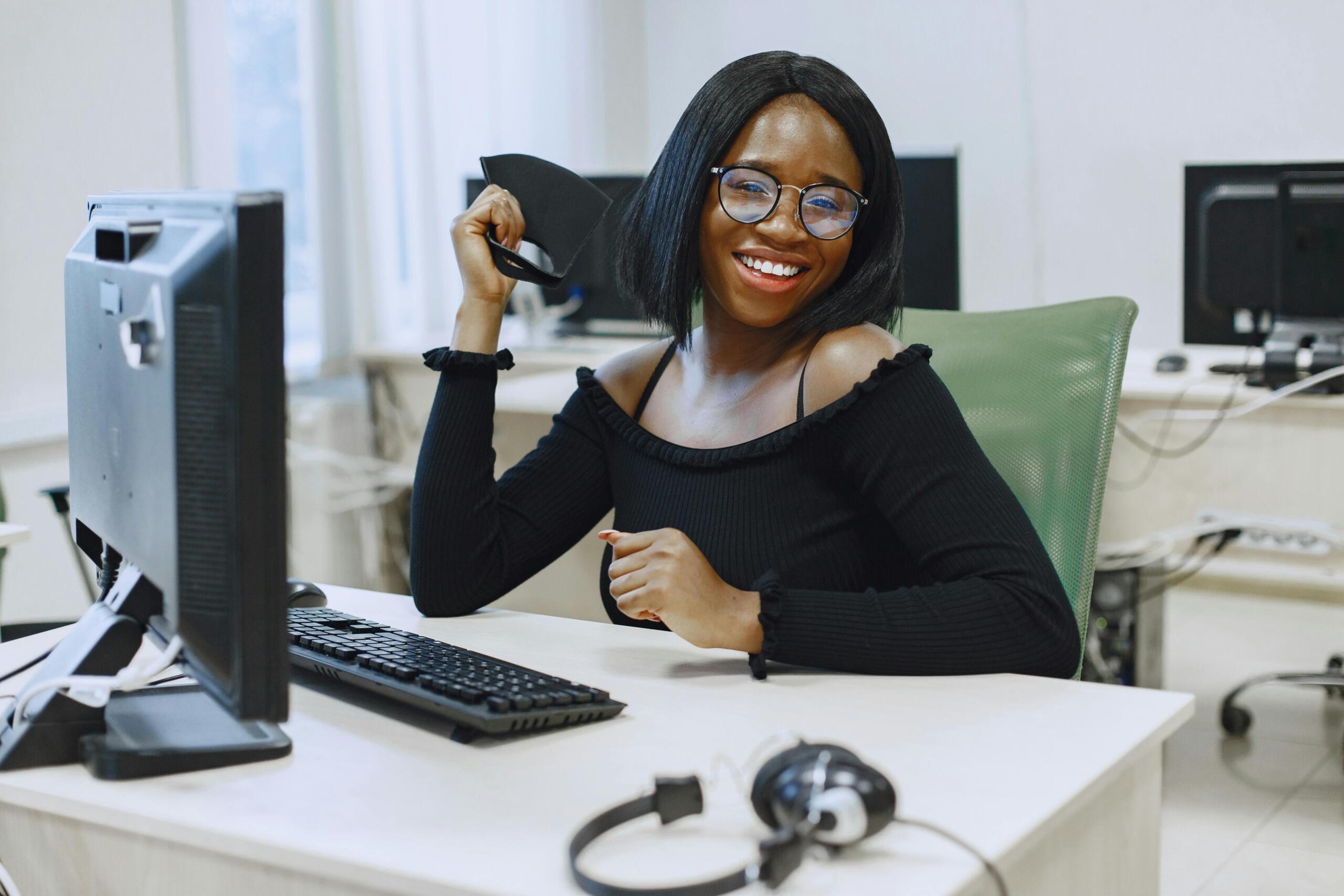 An image of a young woman looking happy in her workplace.