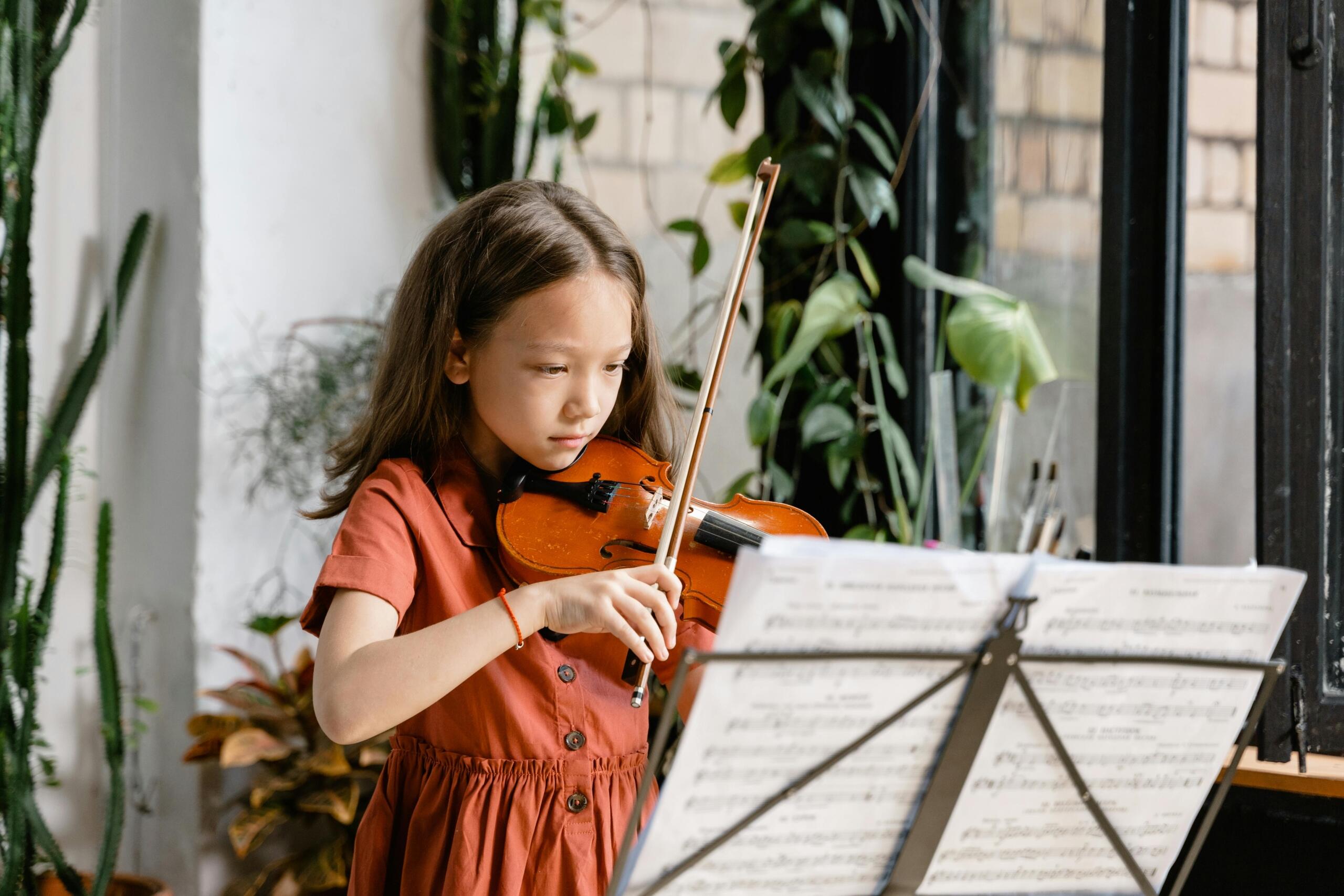 An image of a child practices the violin. 
