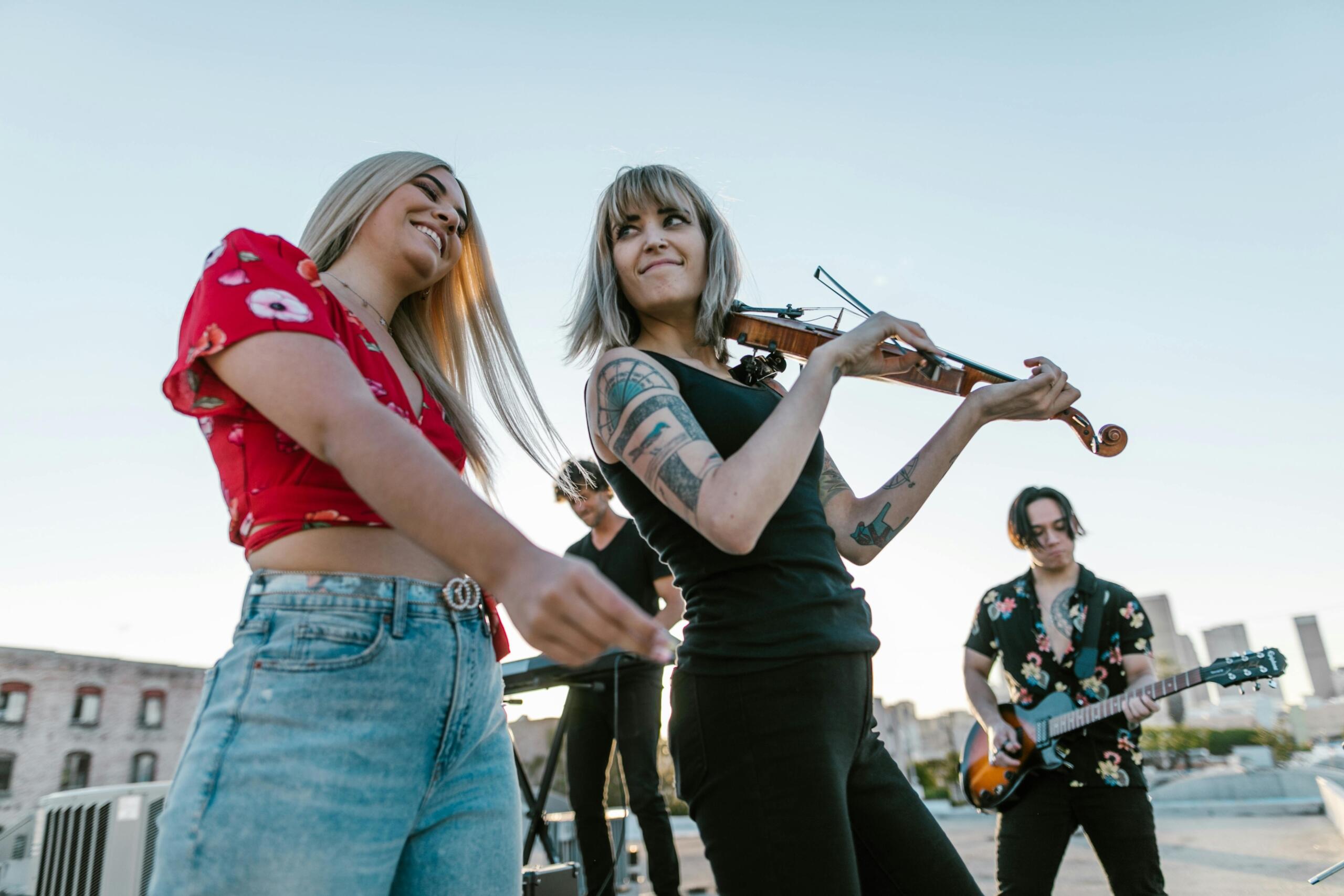 An image of two musicians rocking with a violin.