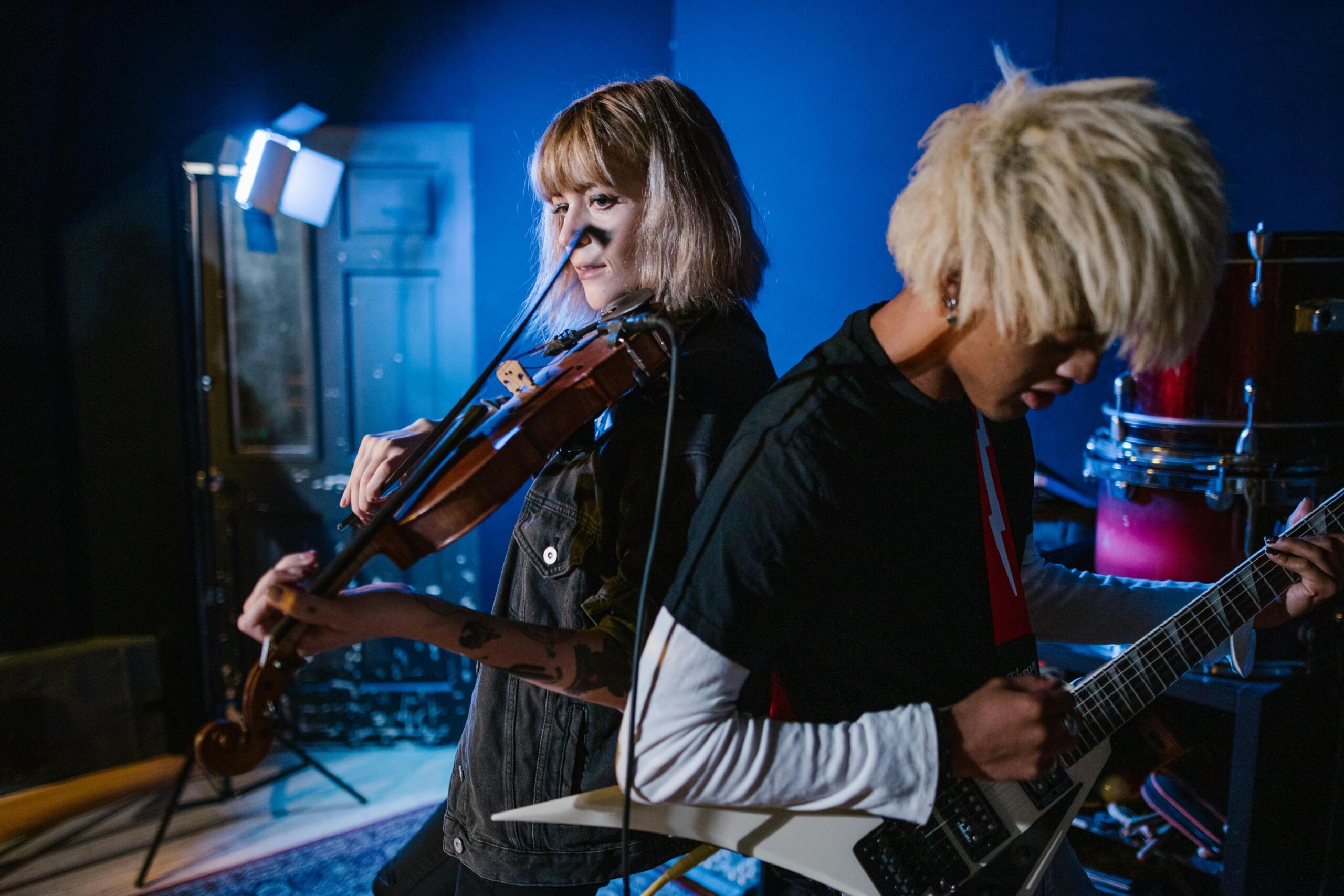 An image of a rock band featuring a violin player, in concert.