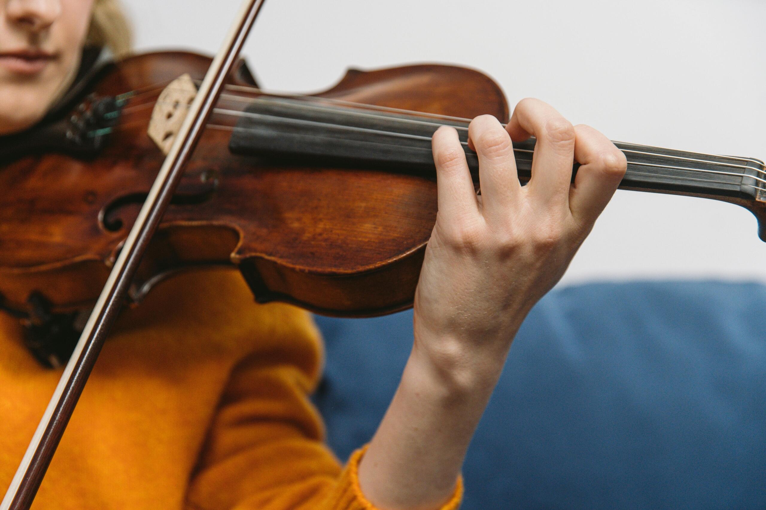 A close up image of a violin being played.