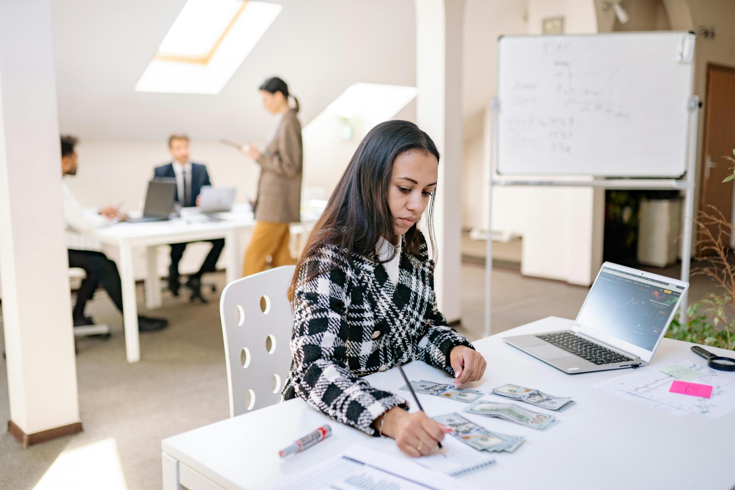 An image of a young woman in an office setting.