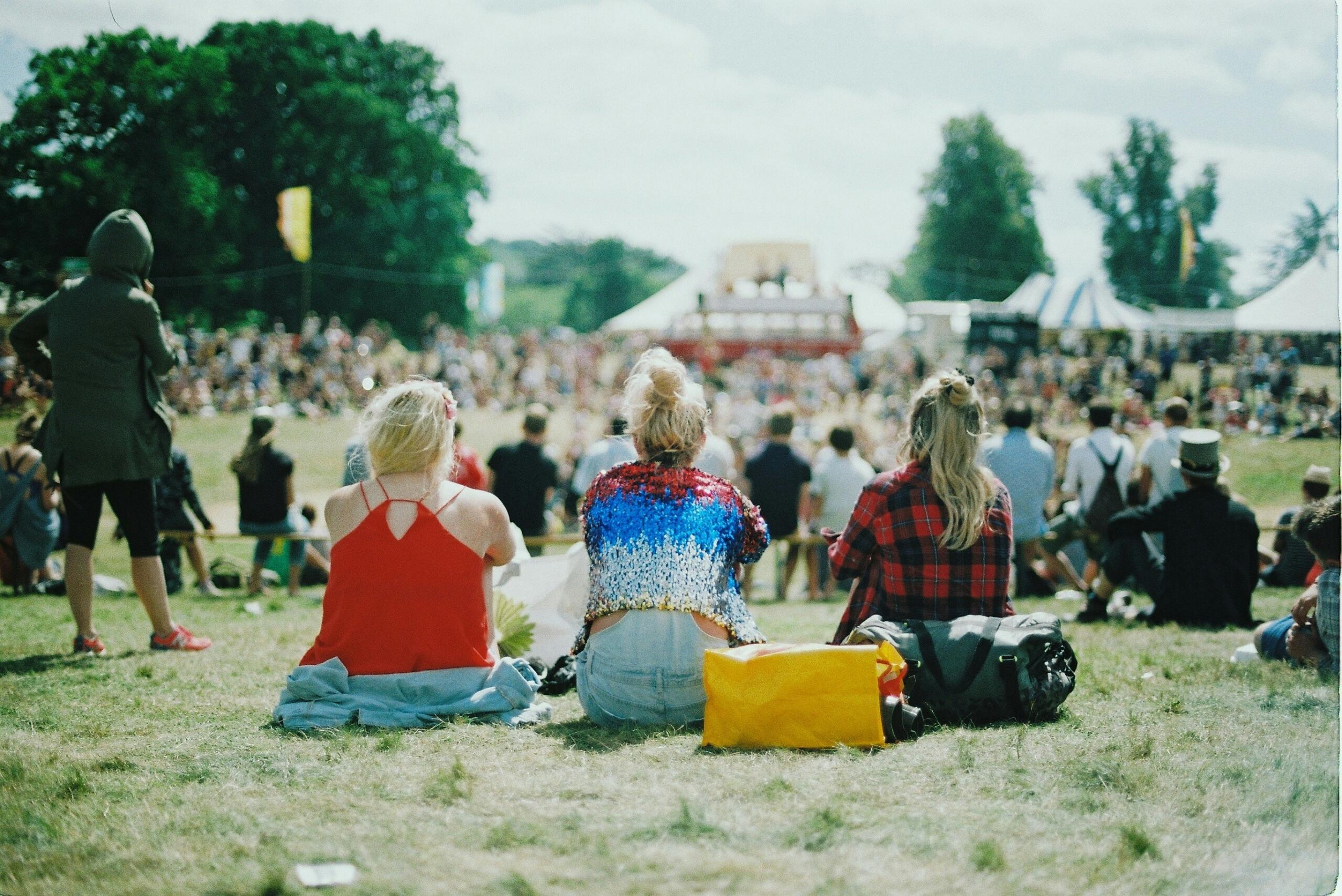 An image of young people enjoying a concert at a festival. 