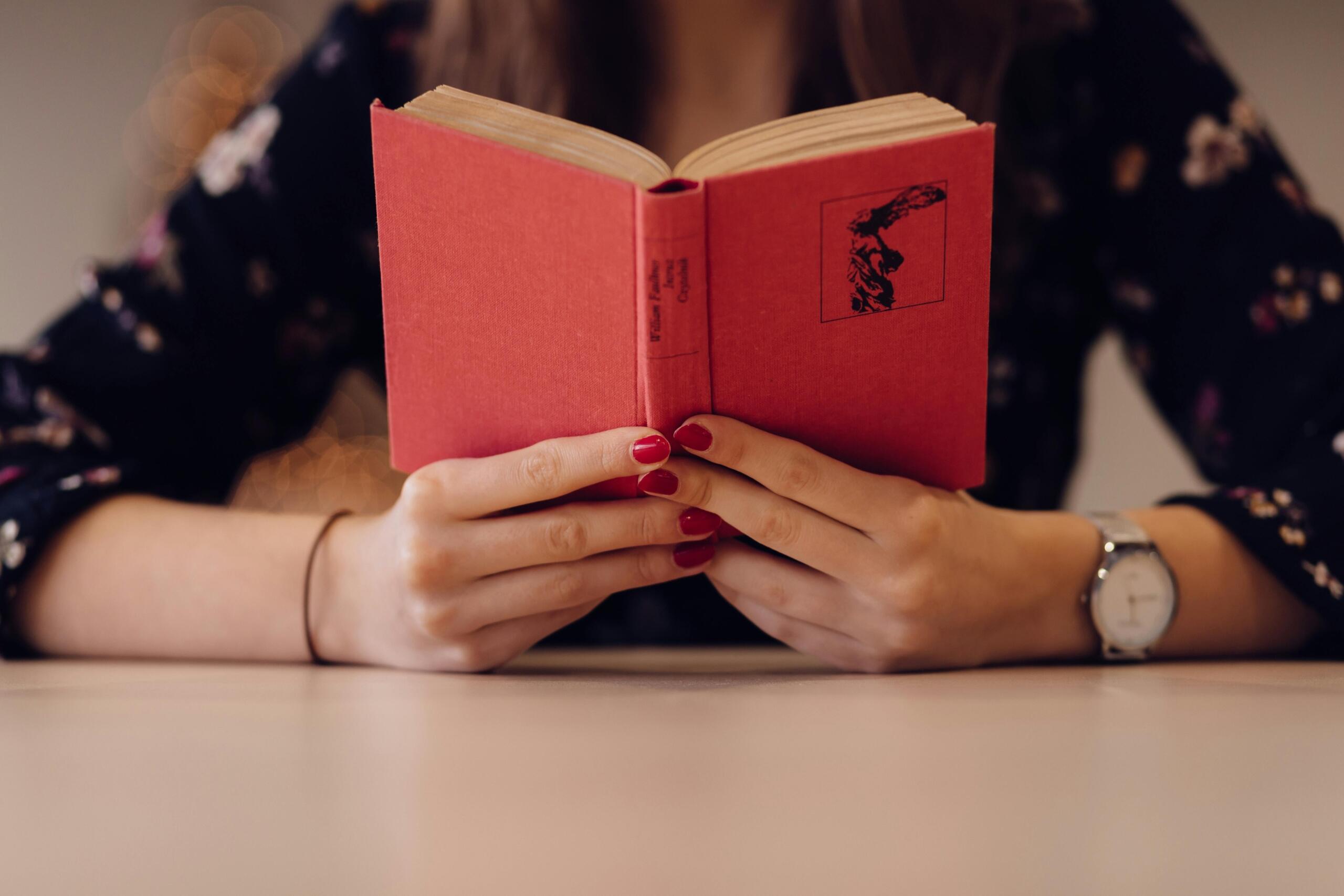 A close-up image of vintage a book being held by hands. 