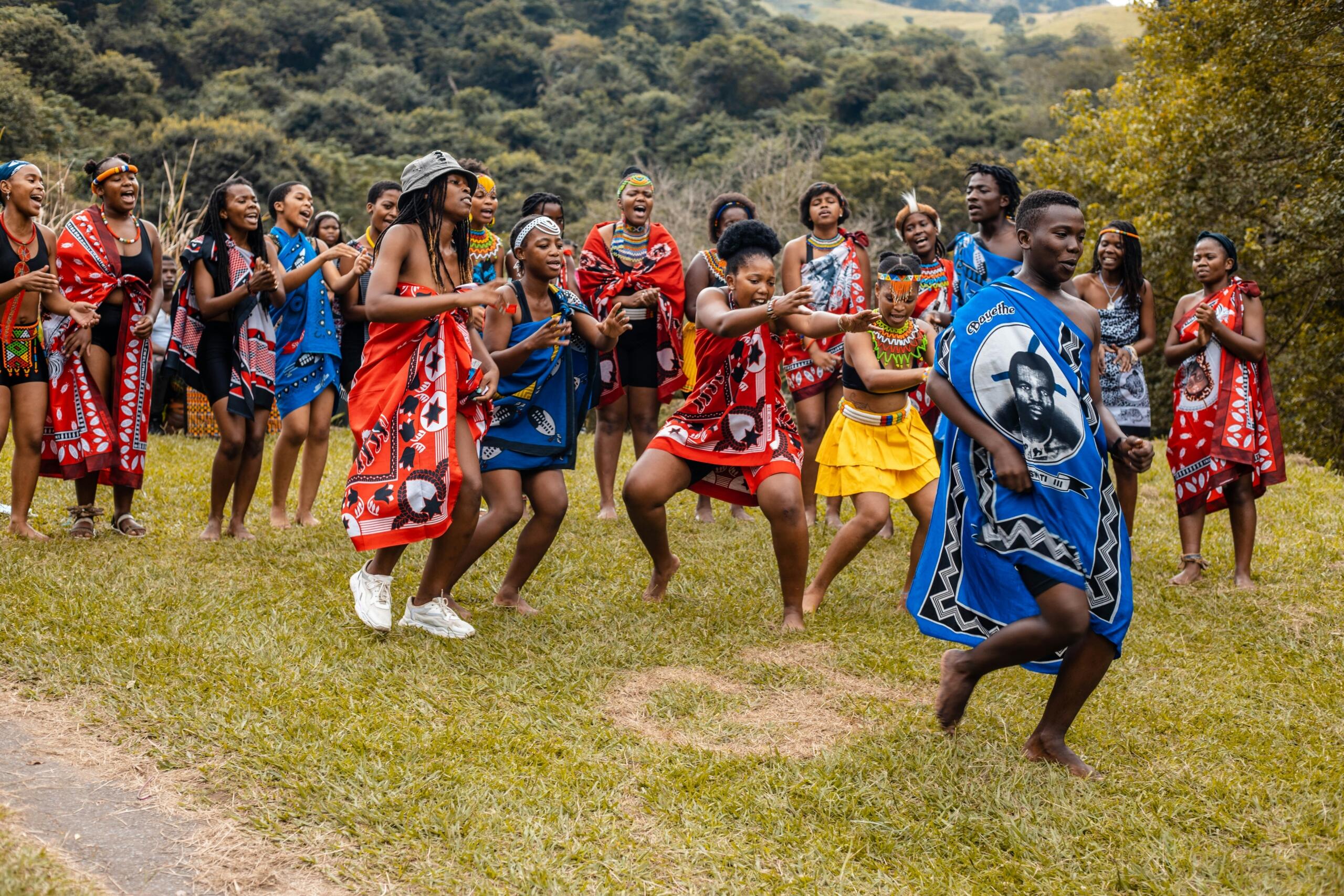 Zulu people dancing traditionally dressed in colourful attire