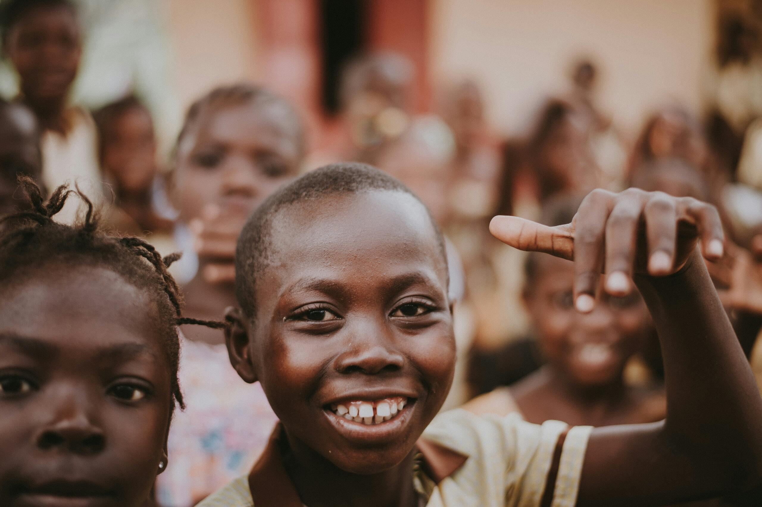 An image of a smiling child in a classroom set up.