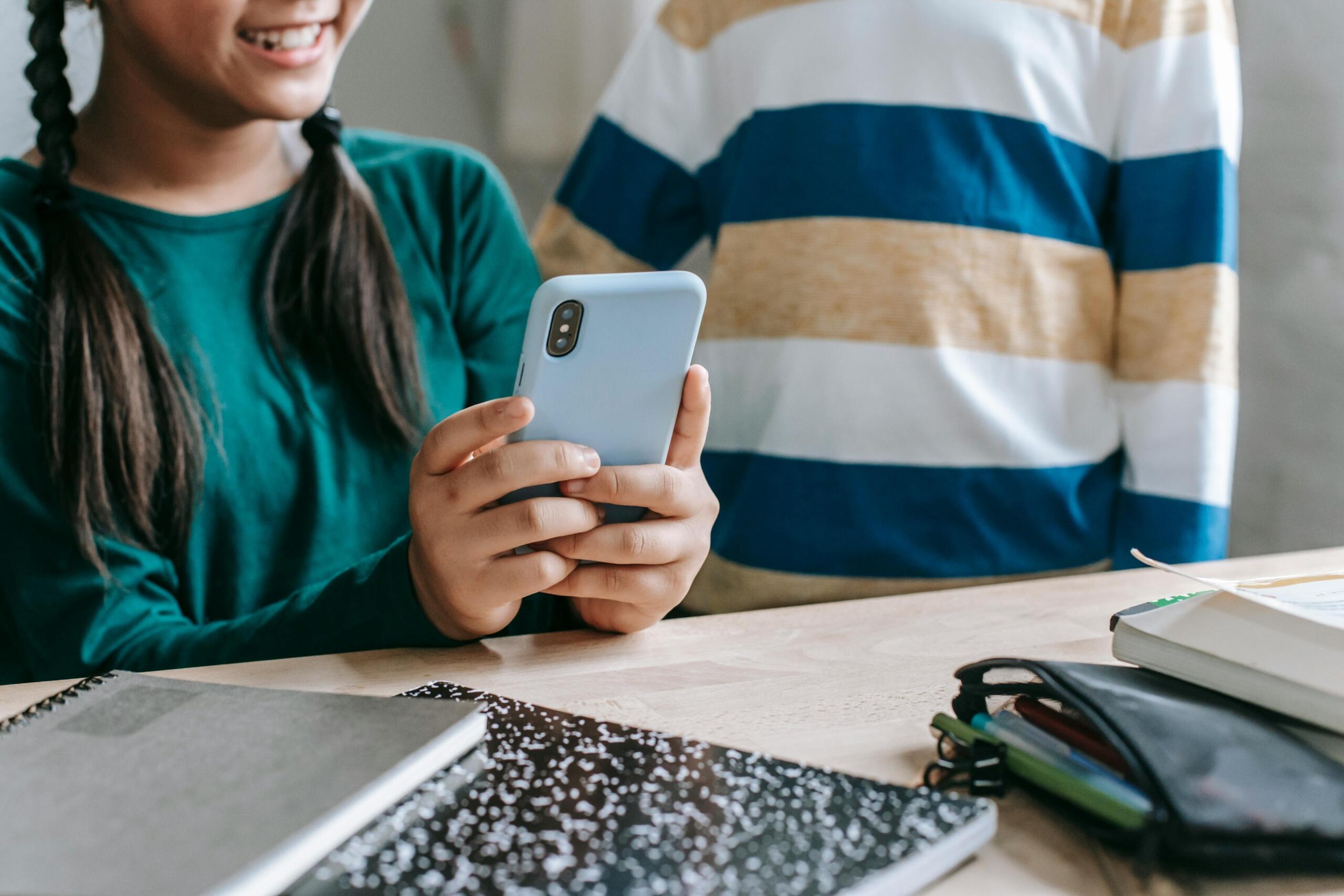 children using a smartphone to do homework
