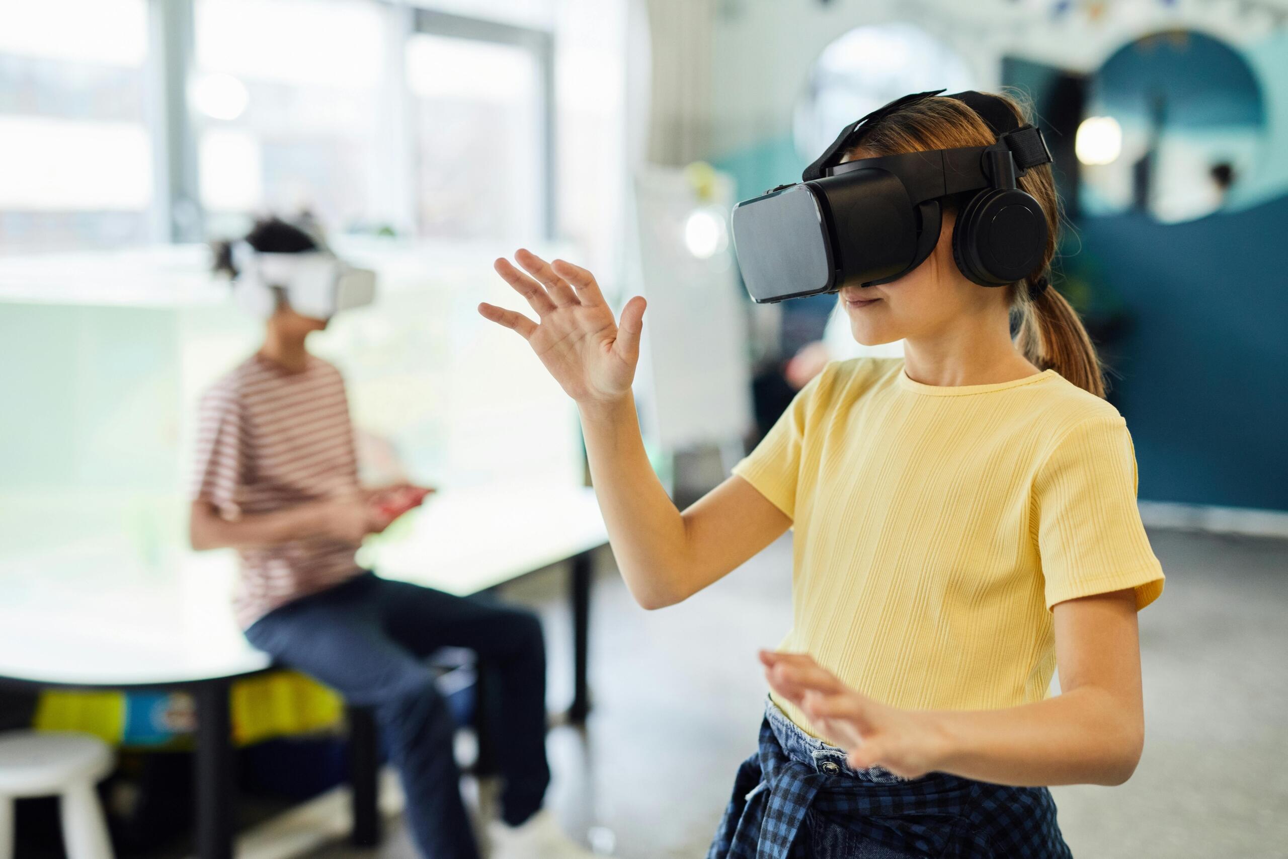 children in a classroom wearing virtual reality headsets