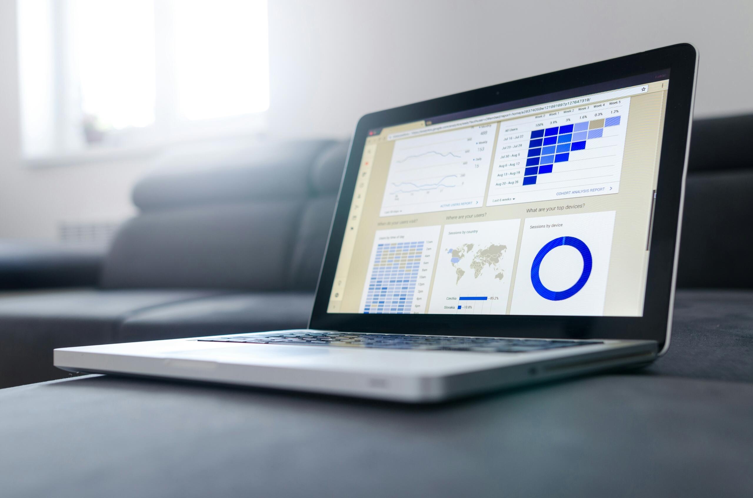 A computer showcasing graphs and pictures on a sofa.