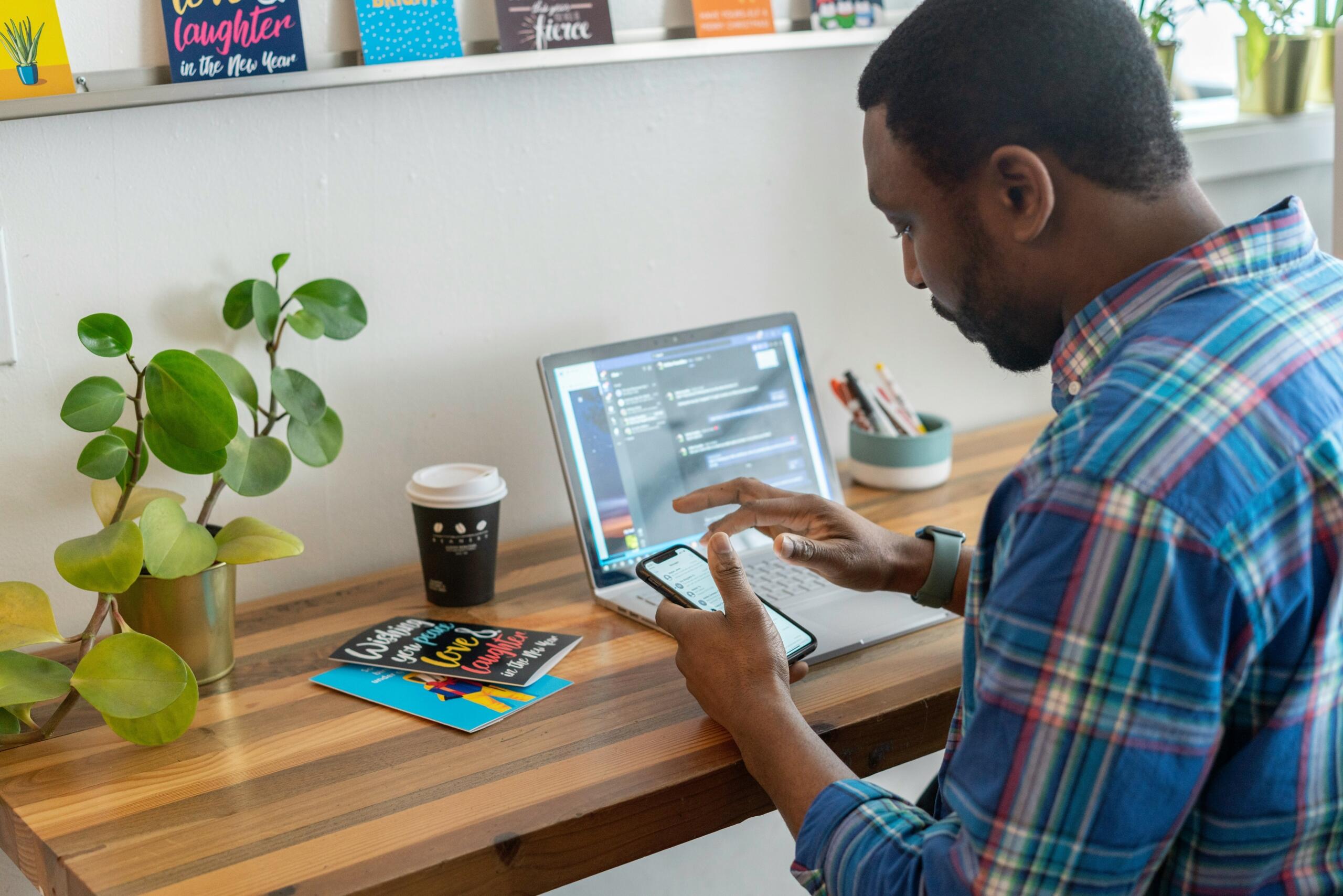 man-in-blue-and-red-check-shirt-using-silver-ipad