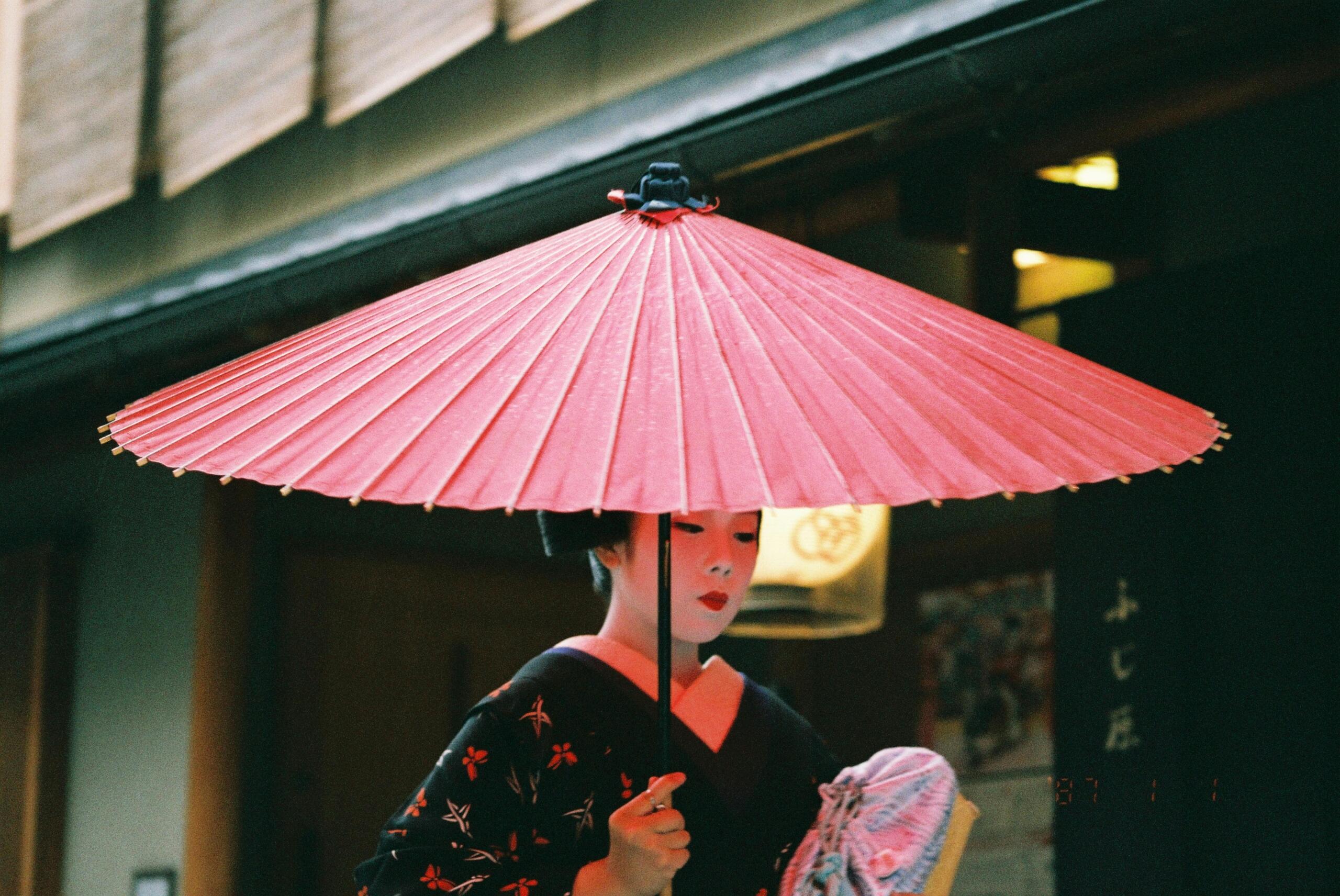 An image of a traditional Japanese woman and umbrella.