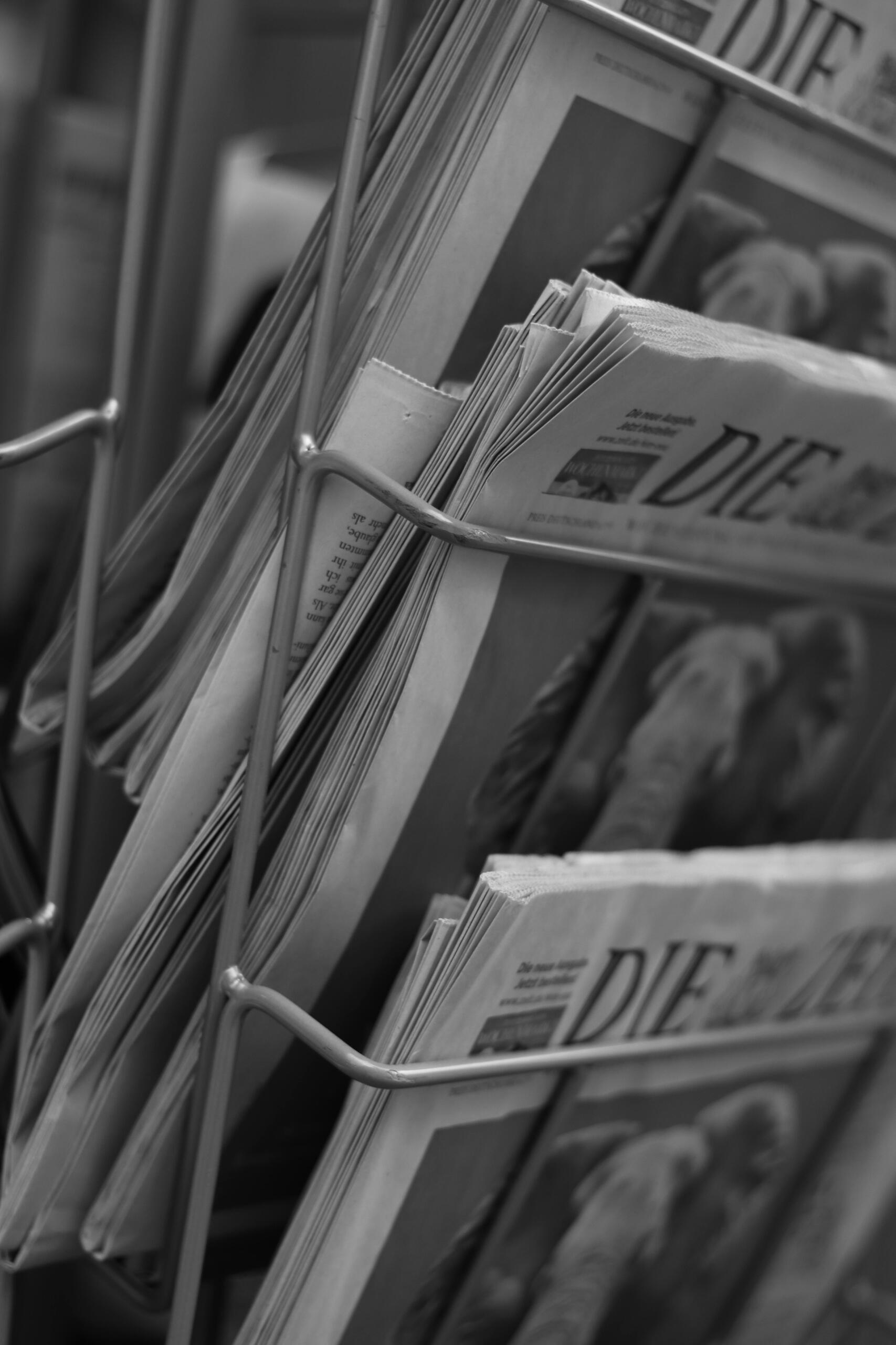 An image of newspapers arranged in a stand.