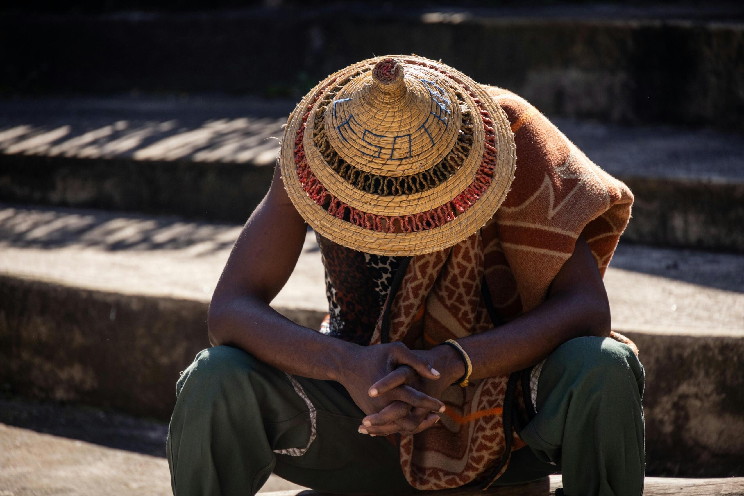 An image of a man showing his Lesotho hat. 