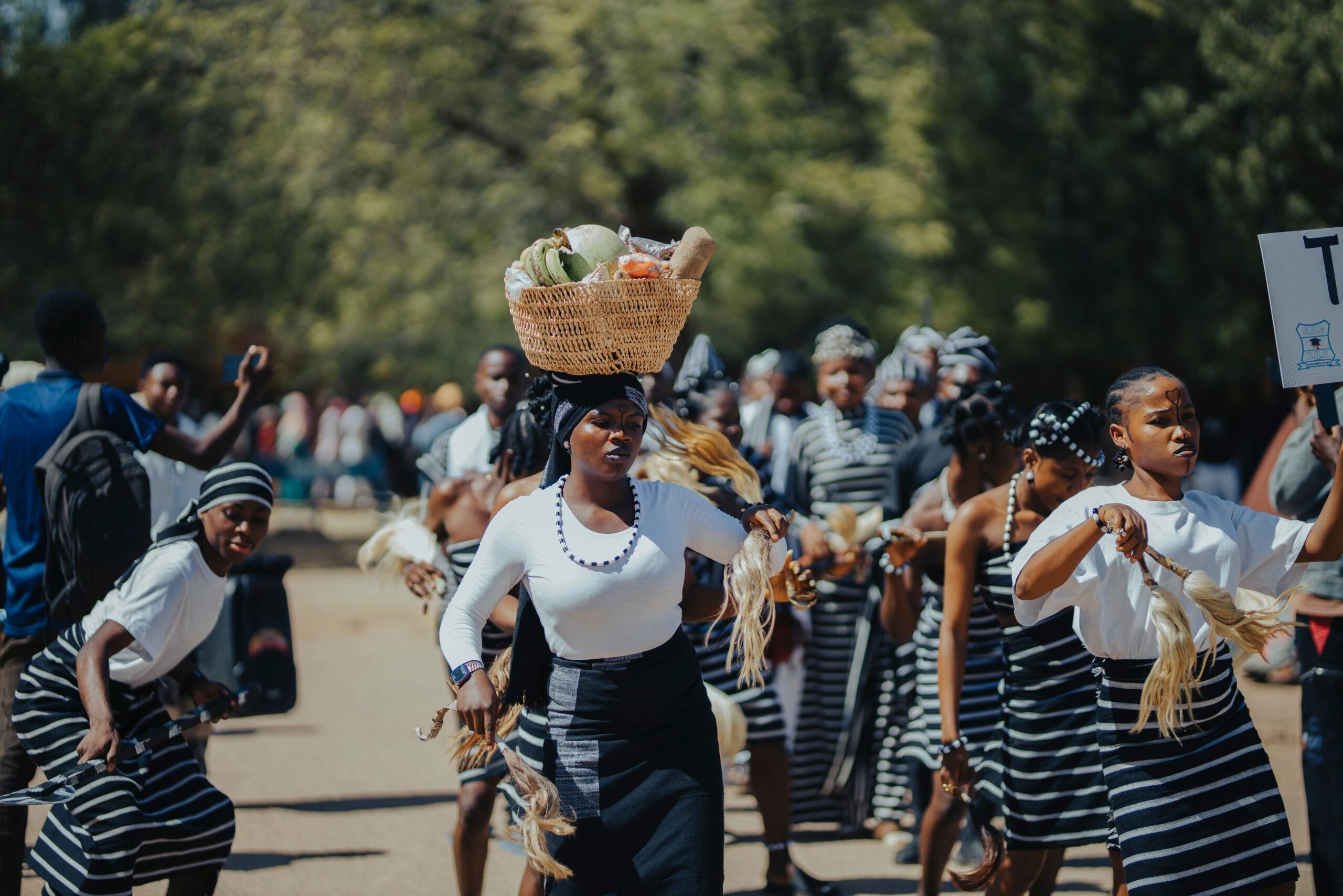 An image of a street scene featuring traditional women.