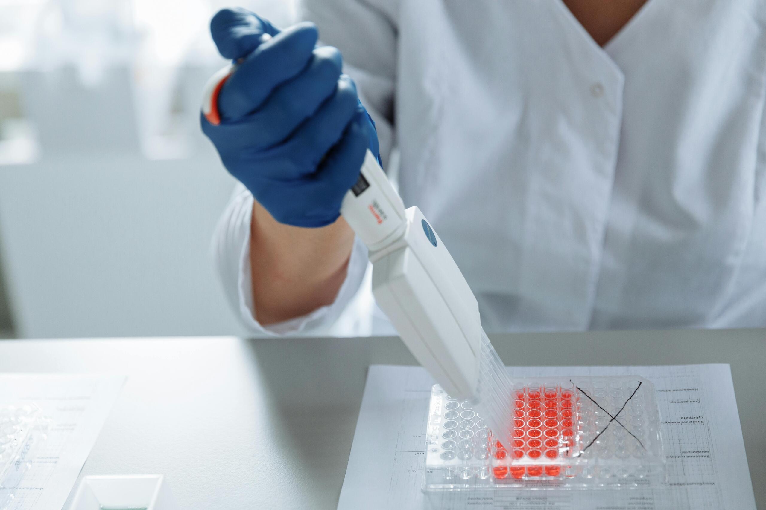 An image of a lab technician working with samples.