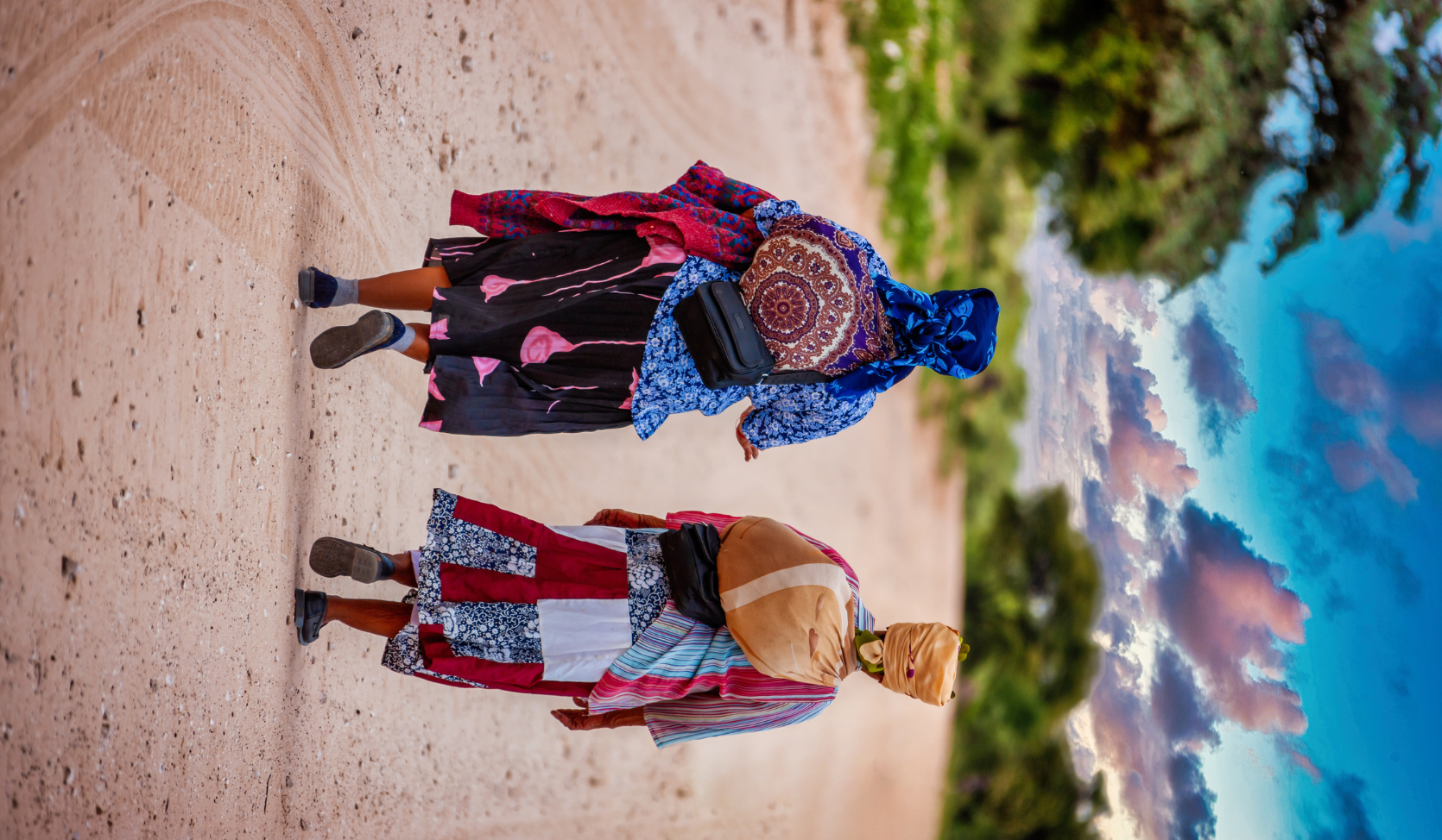two San women wearing traditional clothing and headdresses