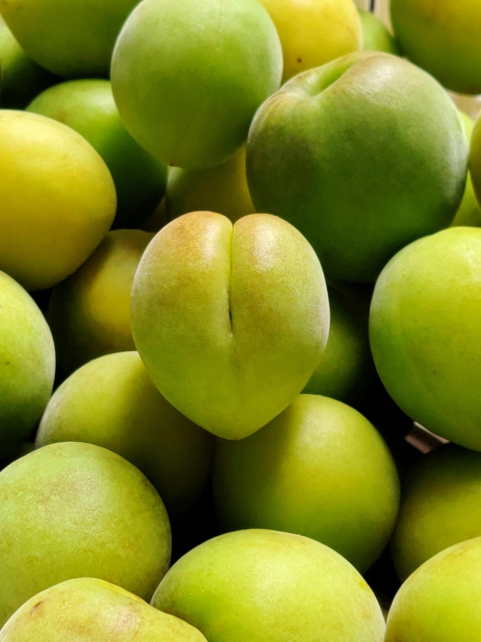 A close-up image of a bowl of sour plums