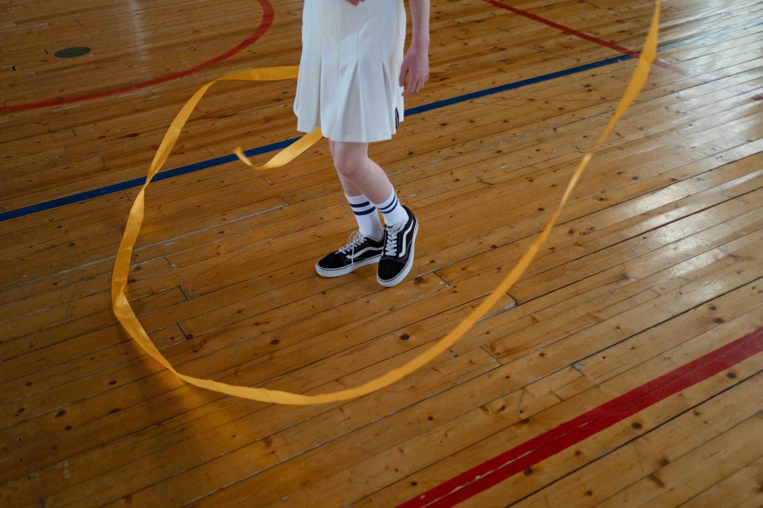 An image of a child's feet in motion as they practice moving with a ribbon.