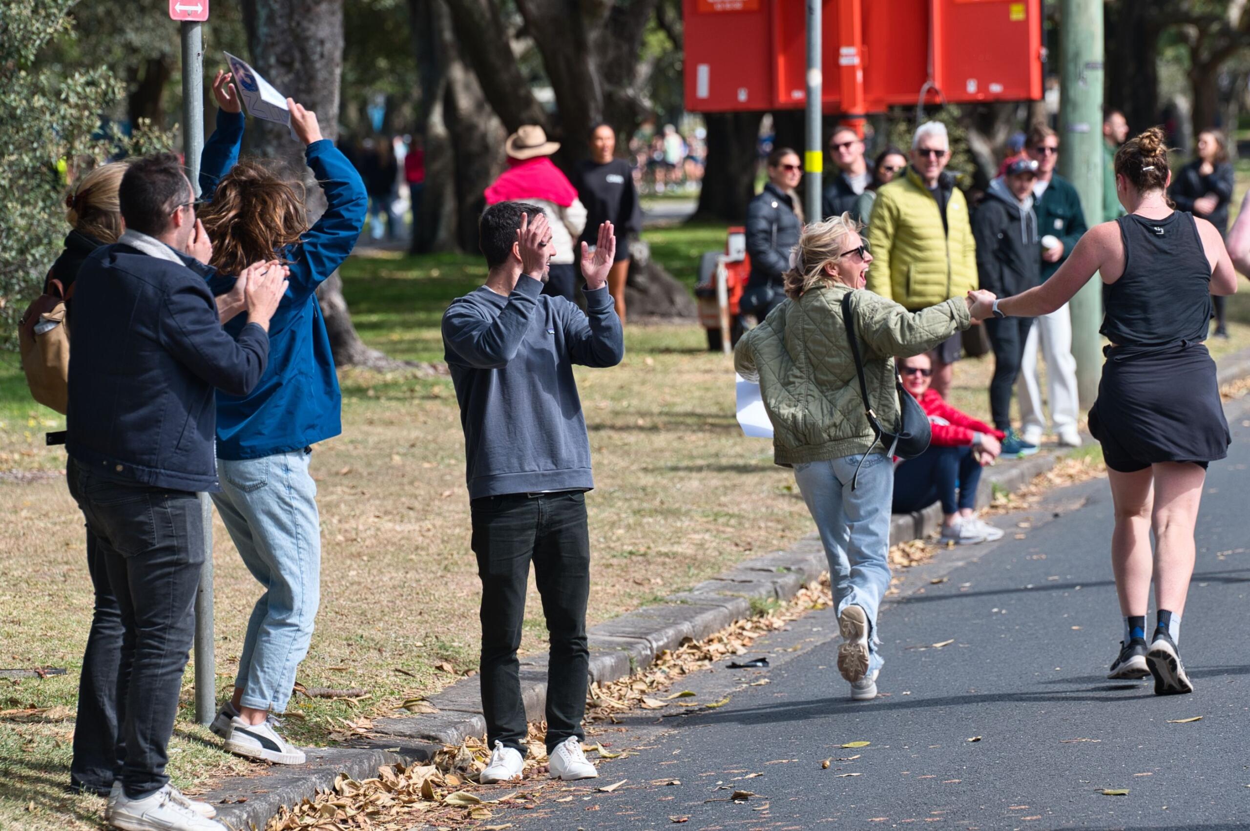 An image of spectators encouraging a marathon participant.