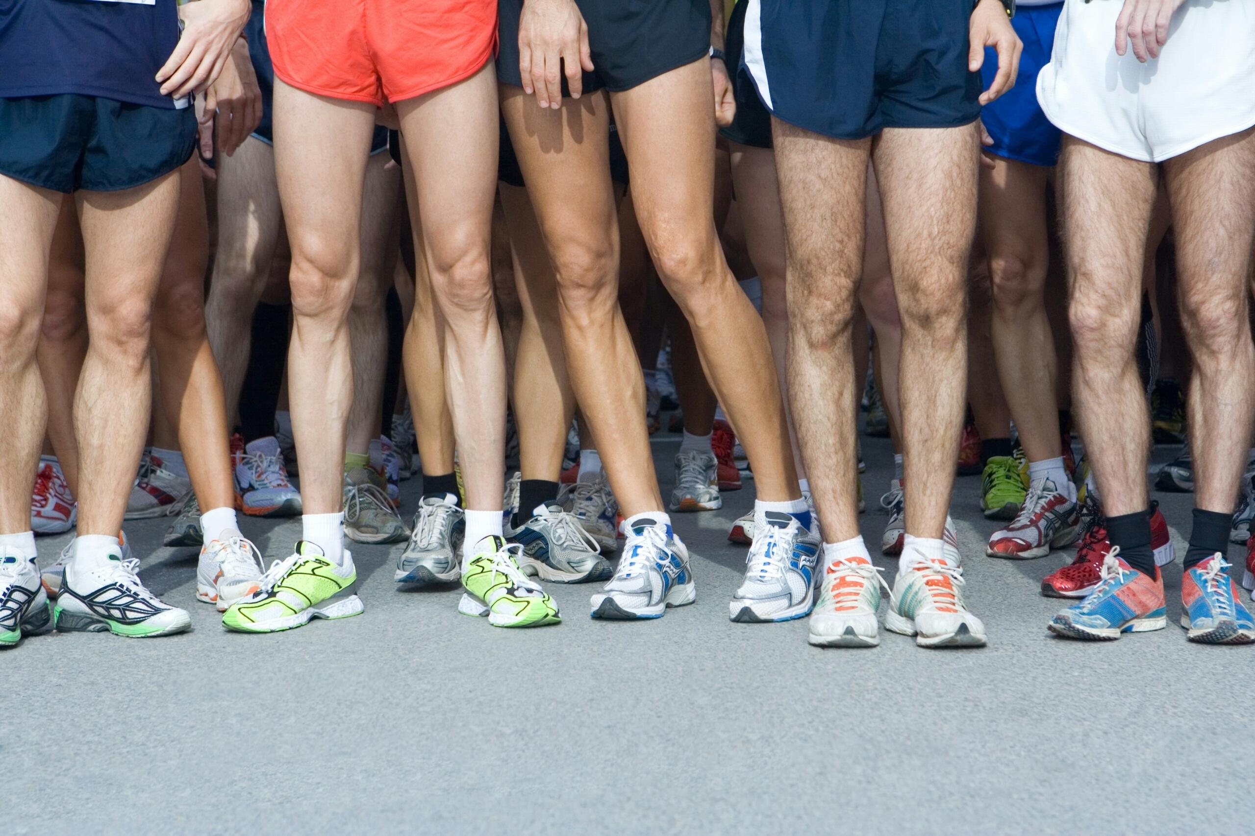 An image of a group of runners' legs.