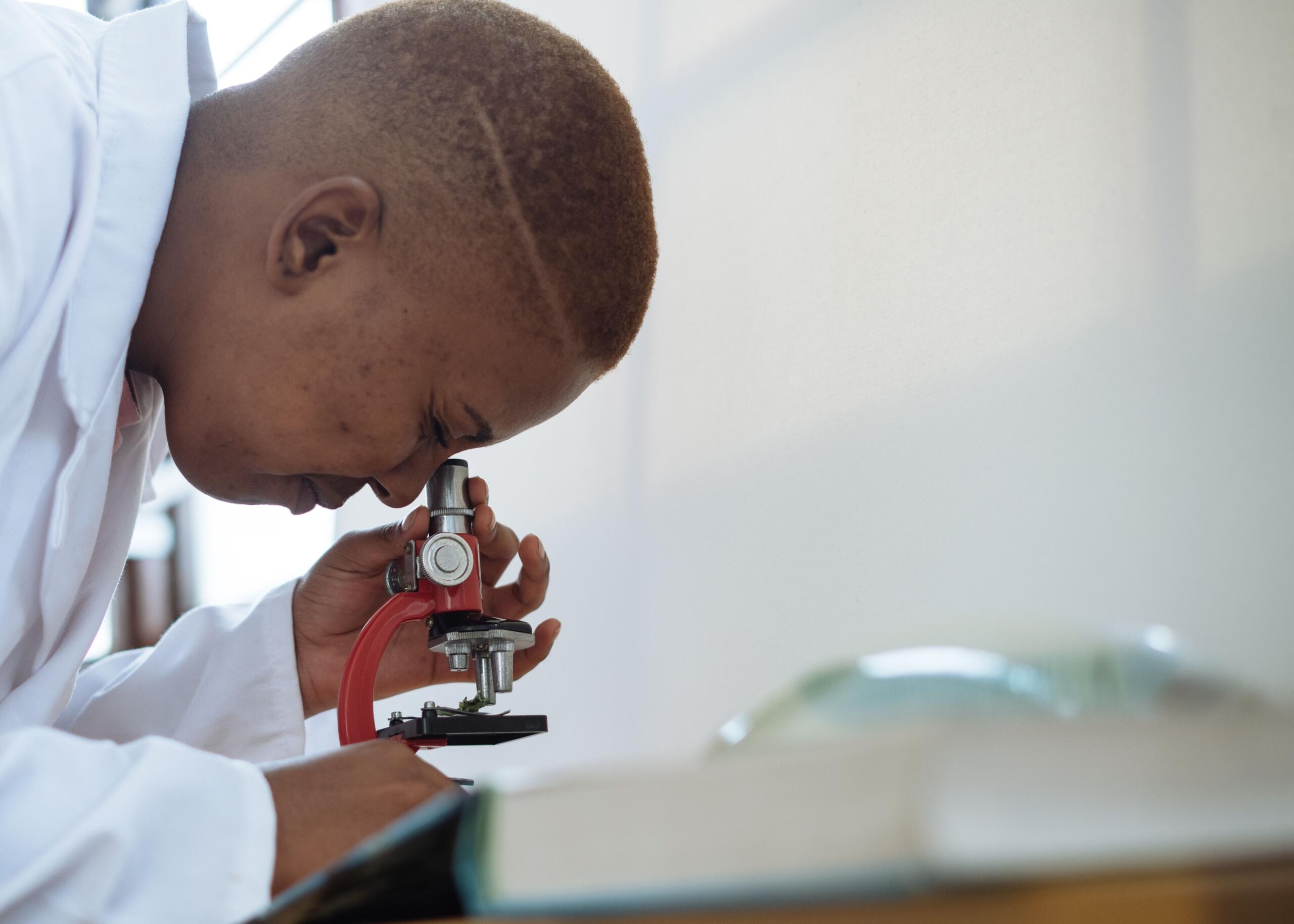 person using a microscope
