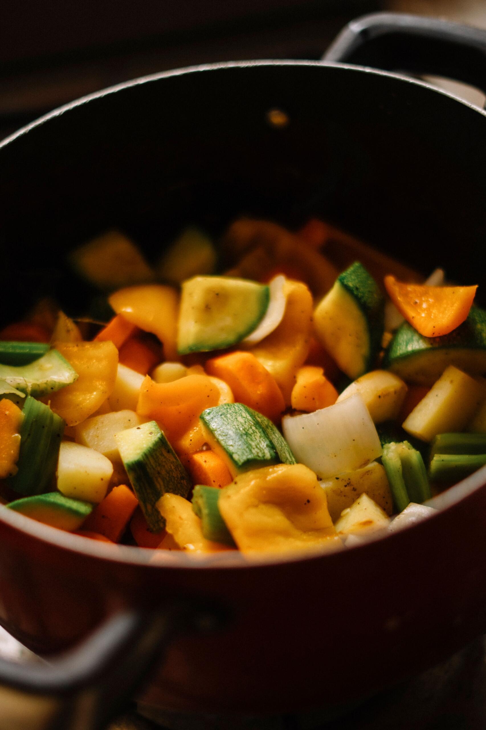 A close up image of roasted winter vegetables in a pot.