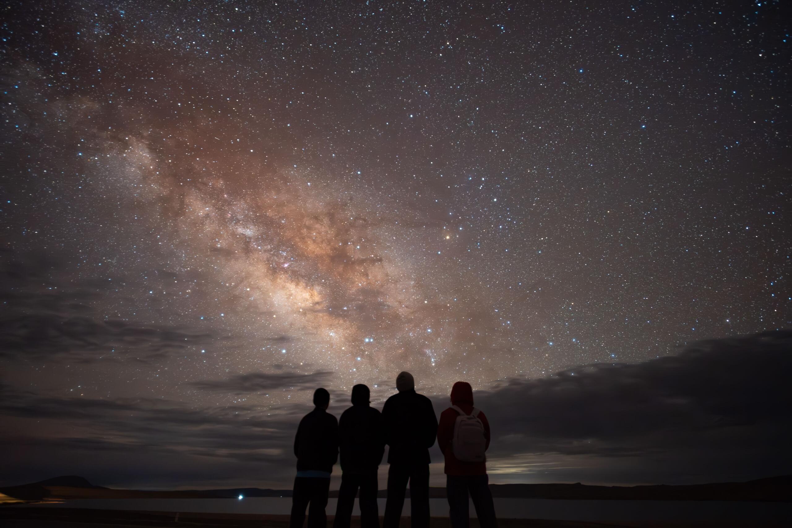 An image of stargazers observing the Milky Way.