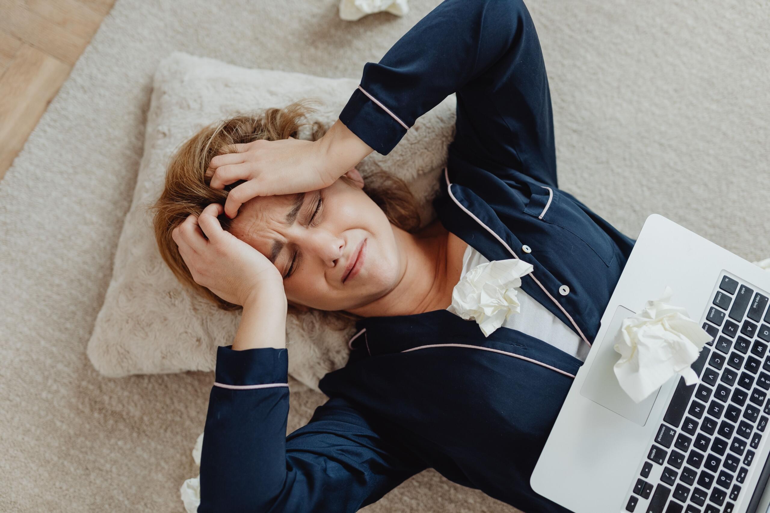 An image of a very stressed woman with a computer
