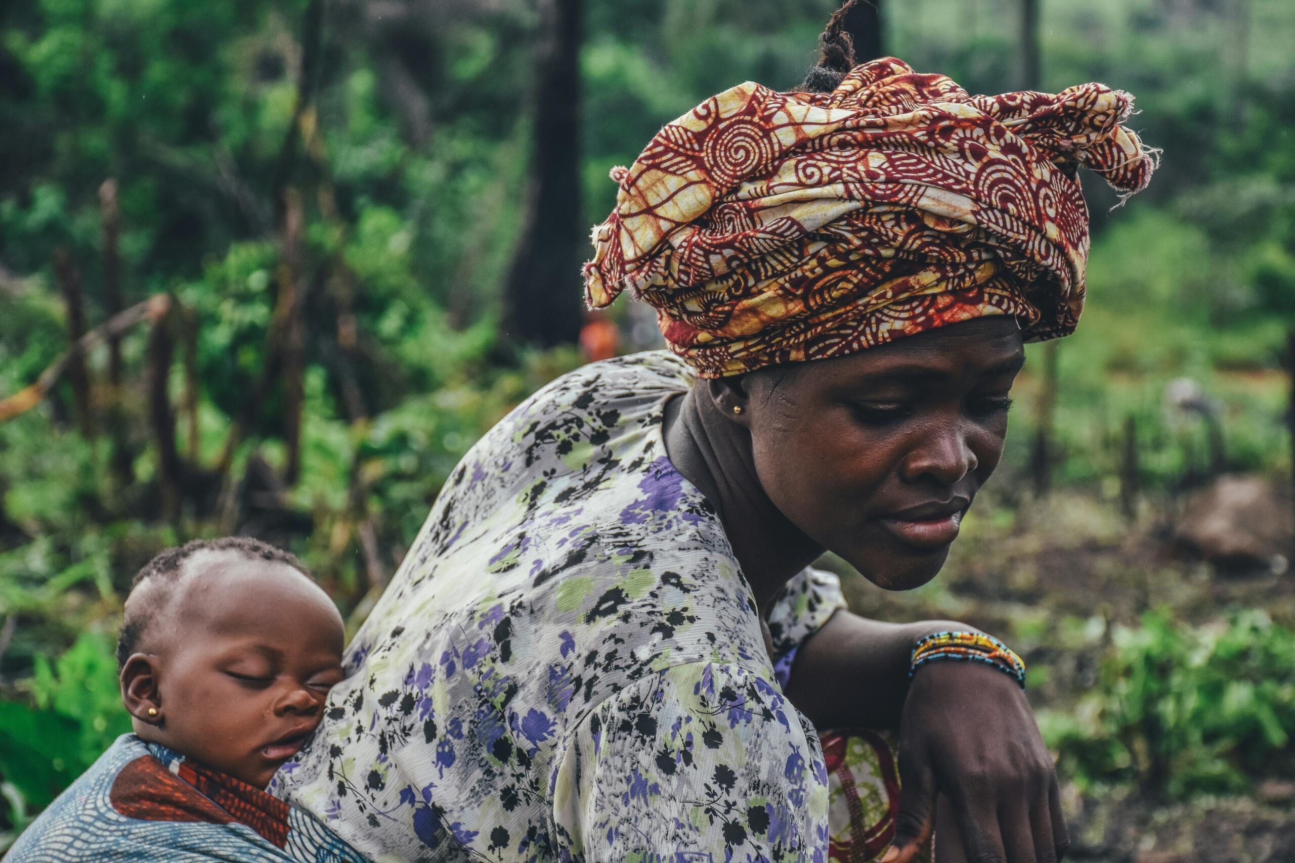 An image of an infant on the back of a mother or grandmother is common in African culture.