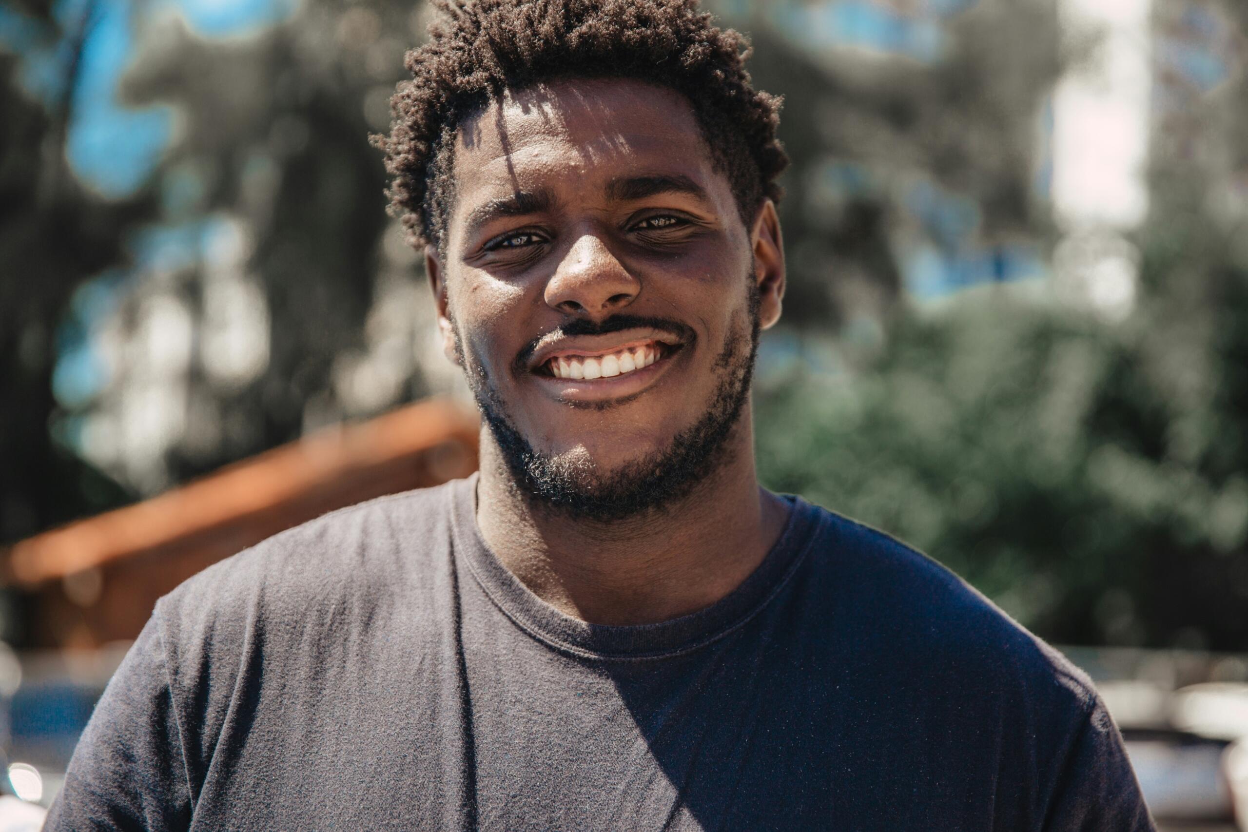 A man staring at the camera and smiling