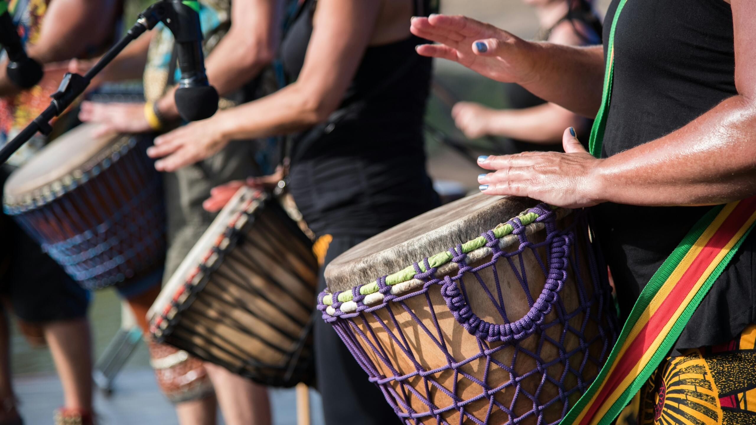 A community playing their traditional drums