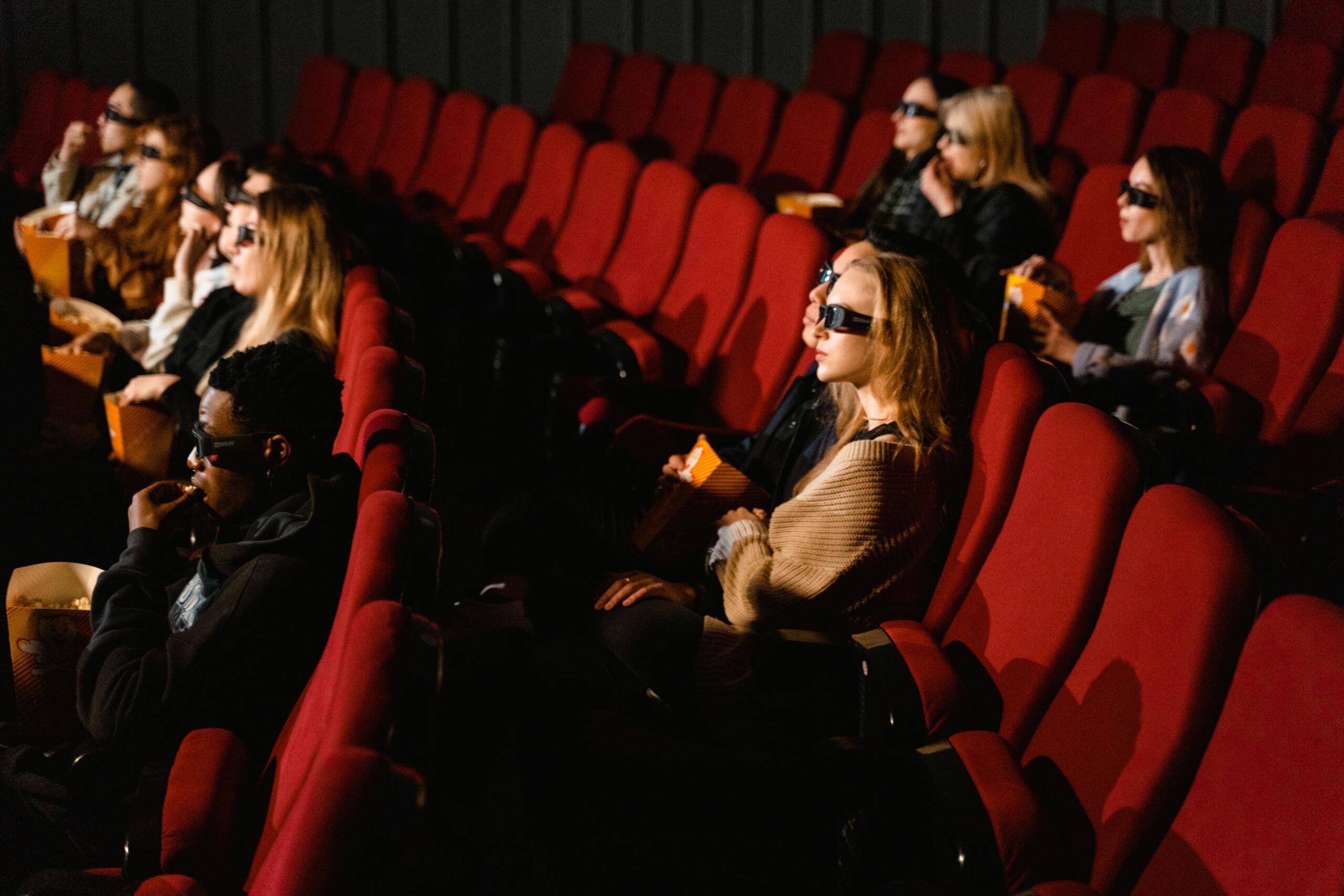 Audience watching a film in a cinema, reflecting the enduring place of The Lion King in popular culture.