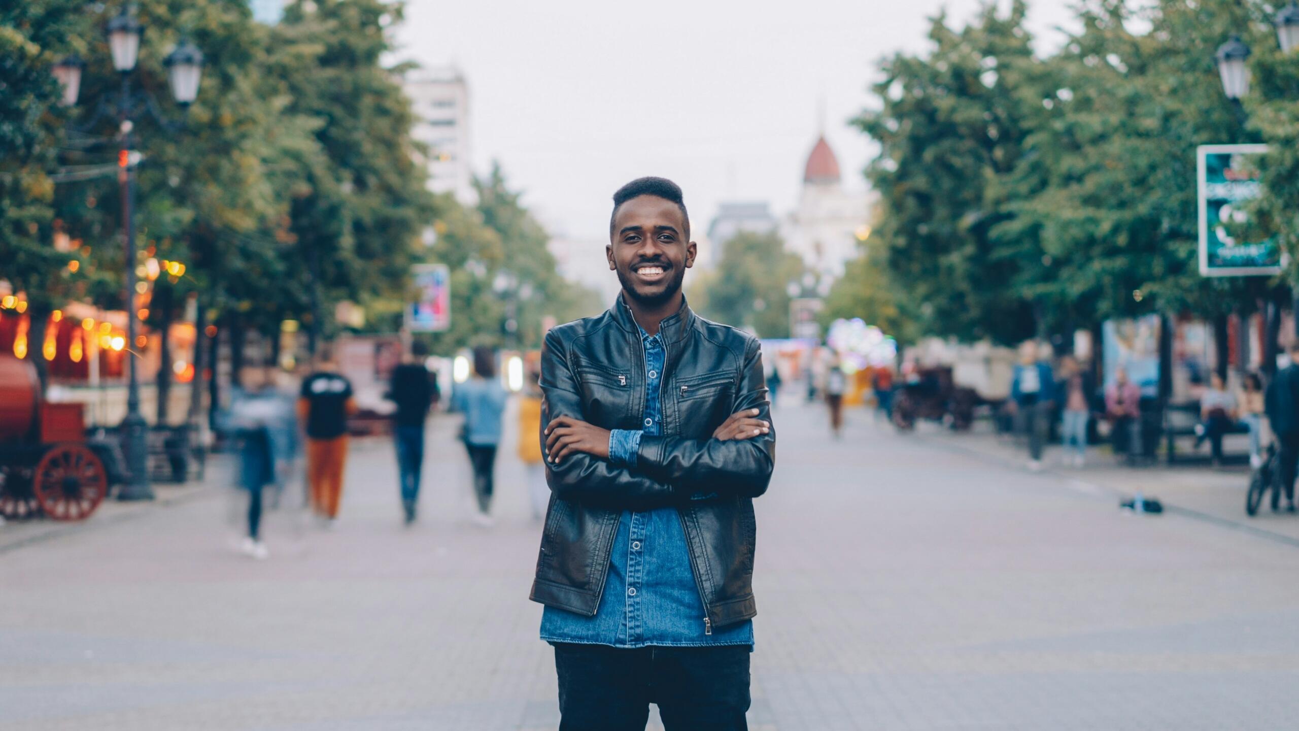 An image of a trendy African man posing in an urban area.