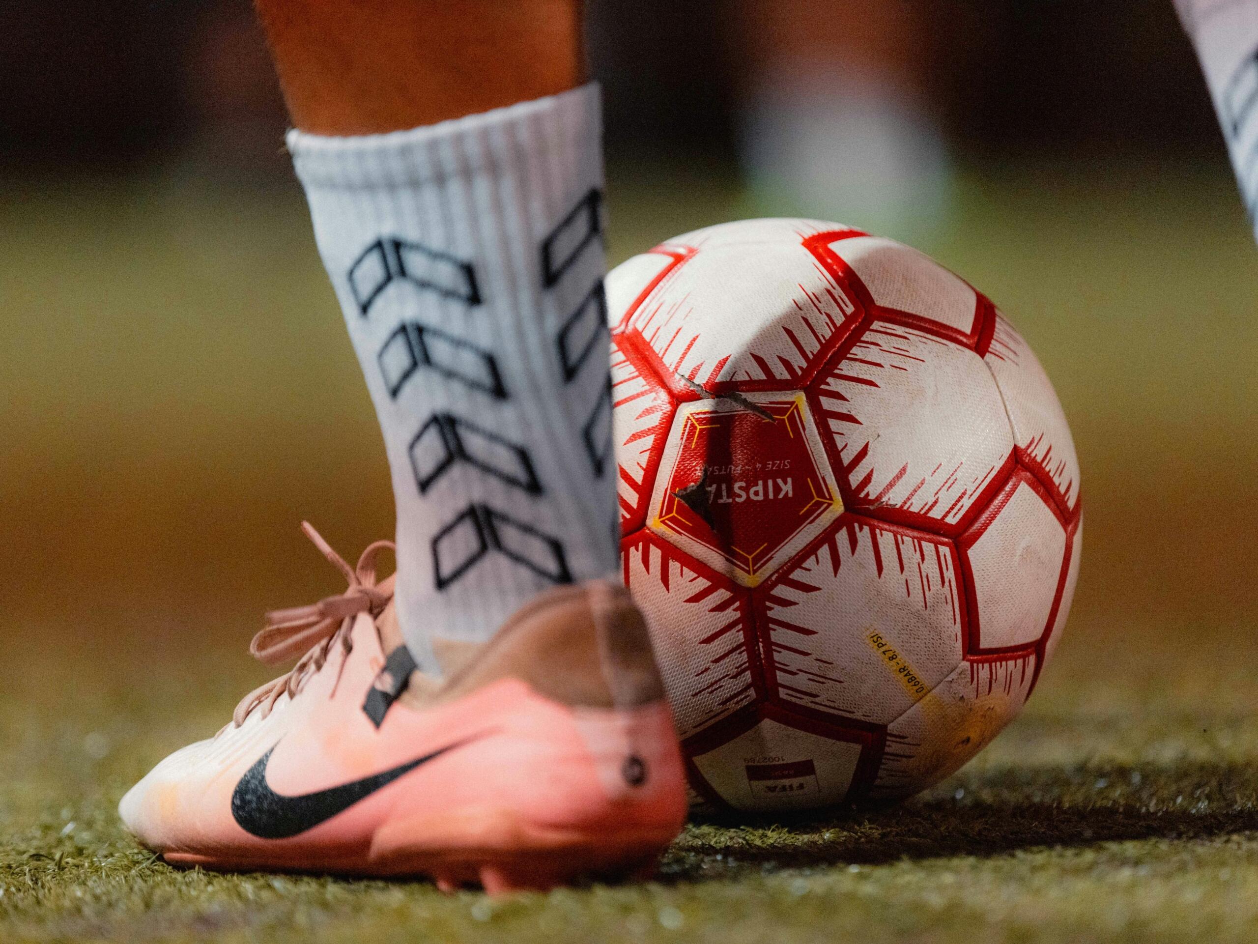 Football boots and ball ready for a match or training session.
