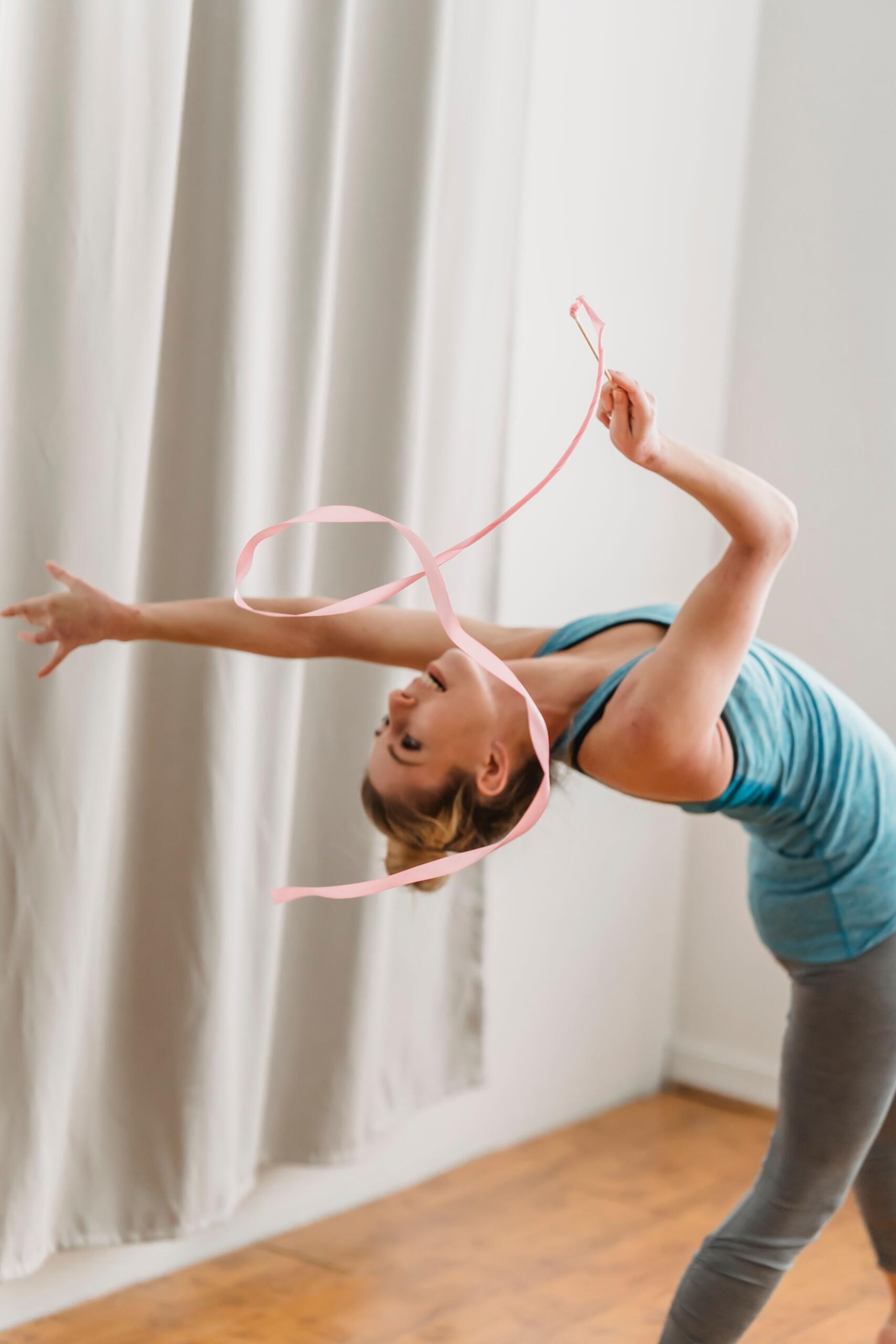 woman practising a rhythmic gymnastics routine with a ribbon