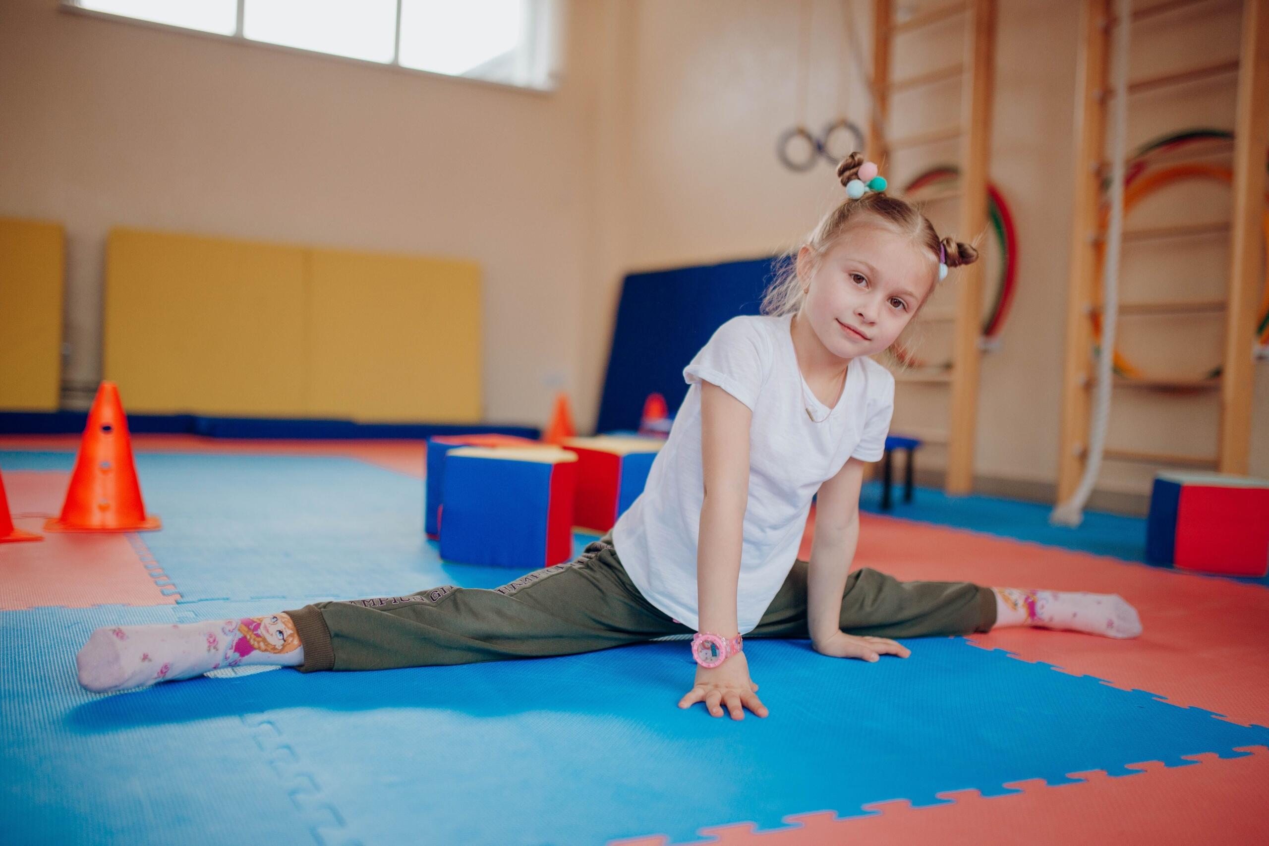 young girl doing the splits in a gymnasium