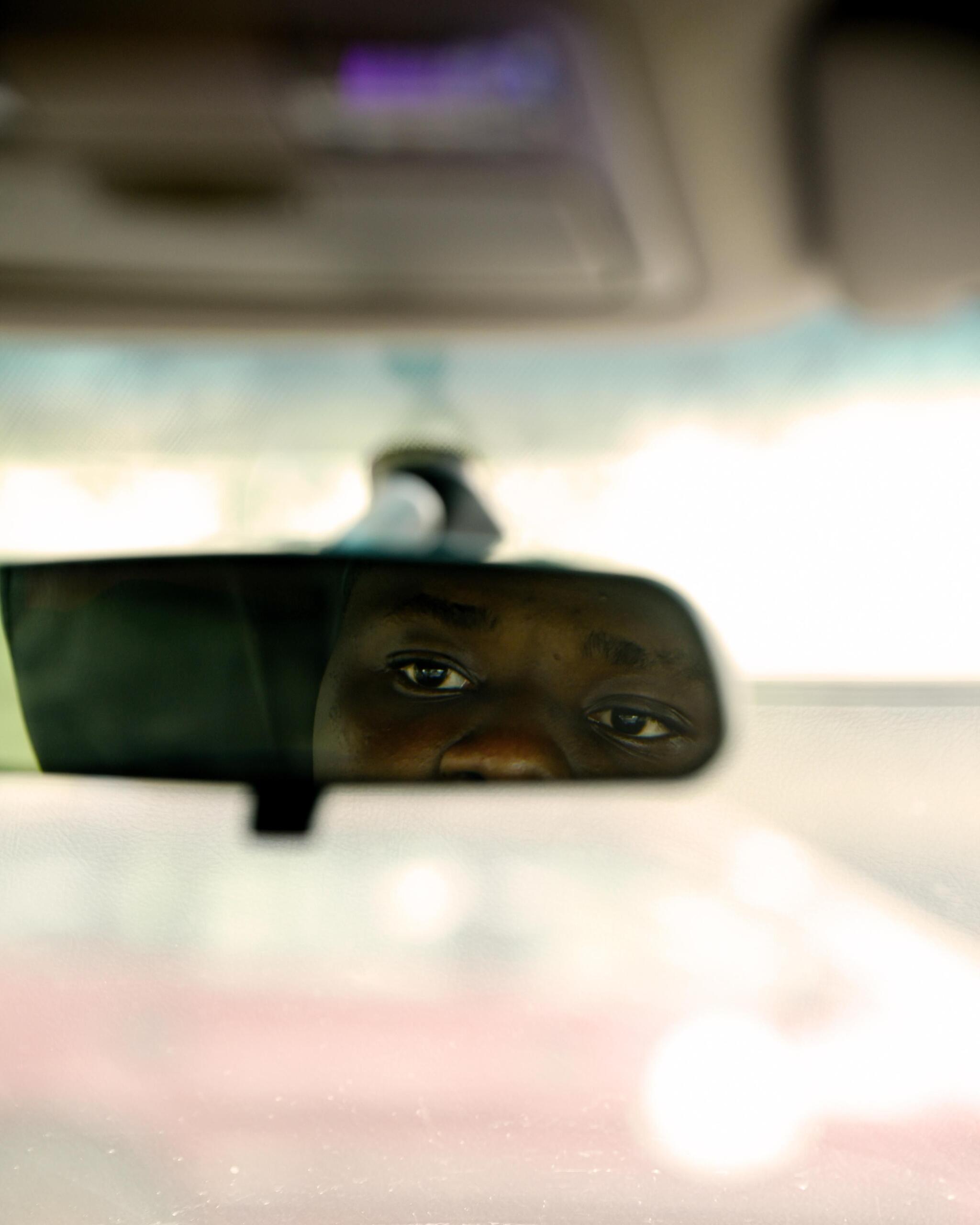 A low depth of field image of a car's rear view mirror