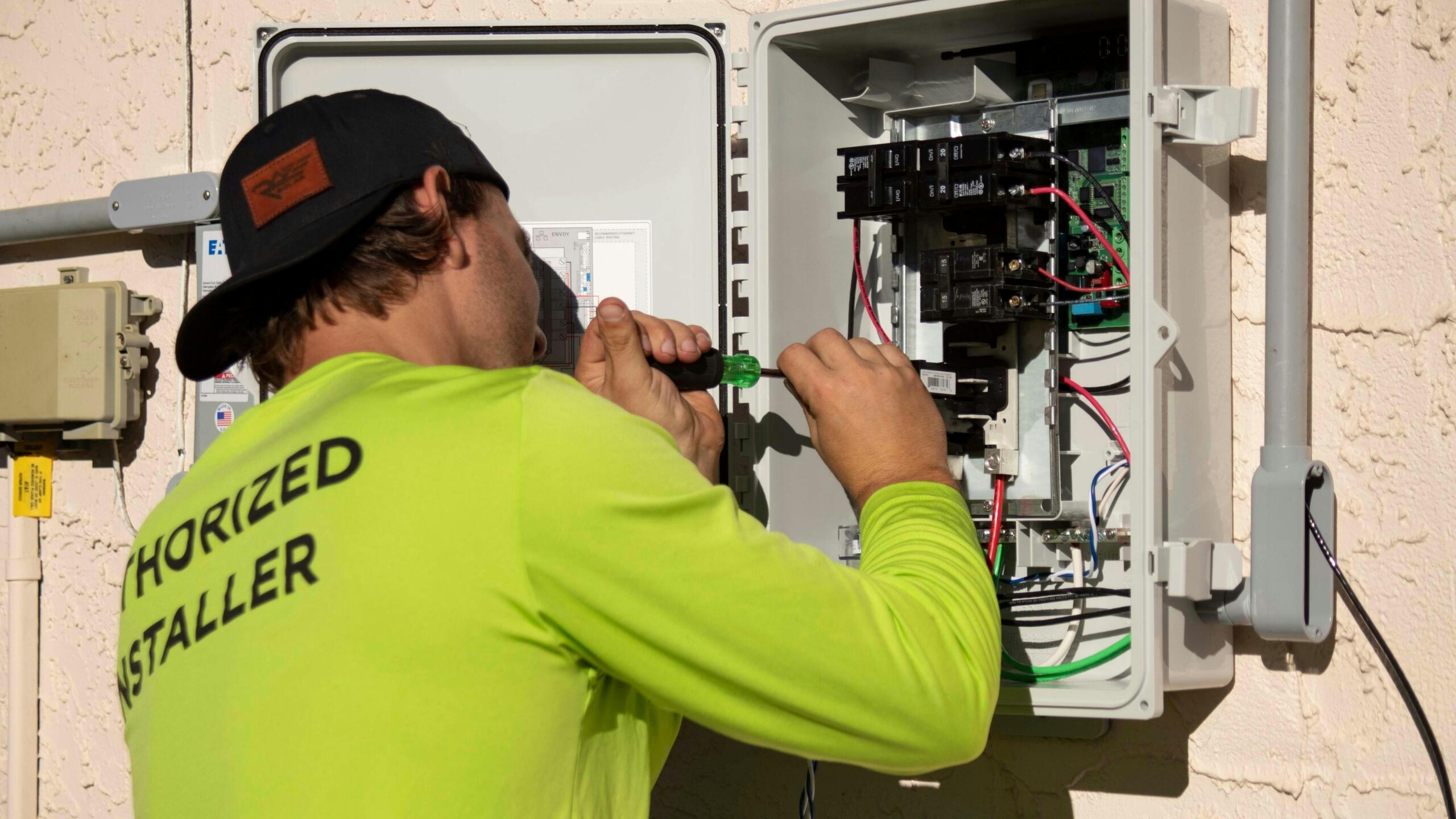 Technician working on an electrical control panel.